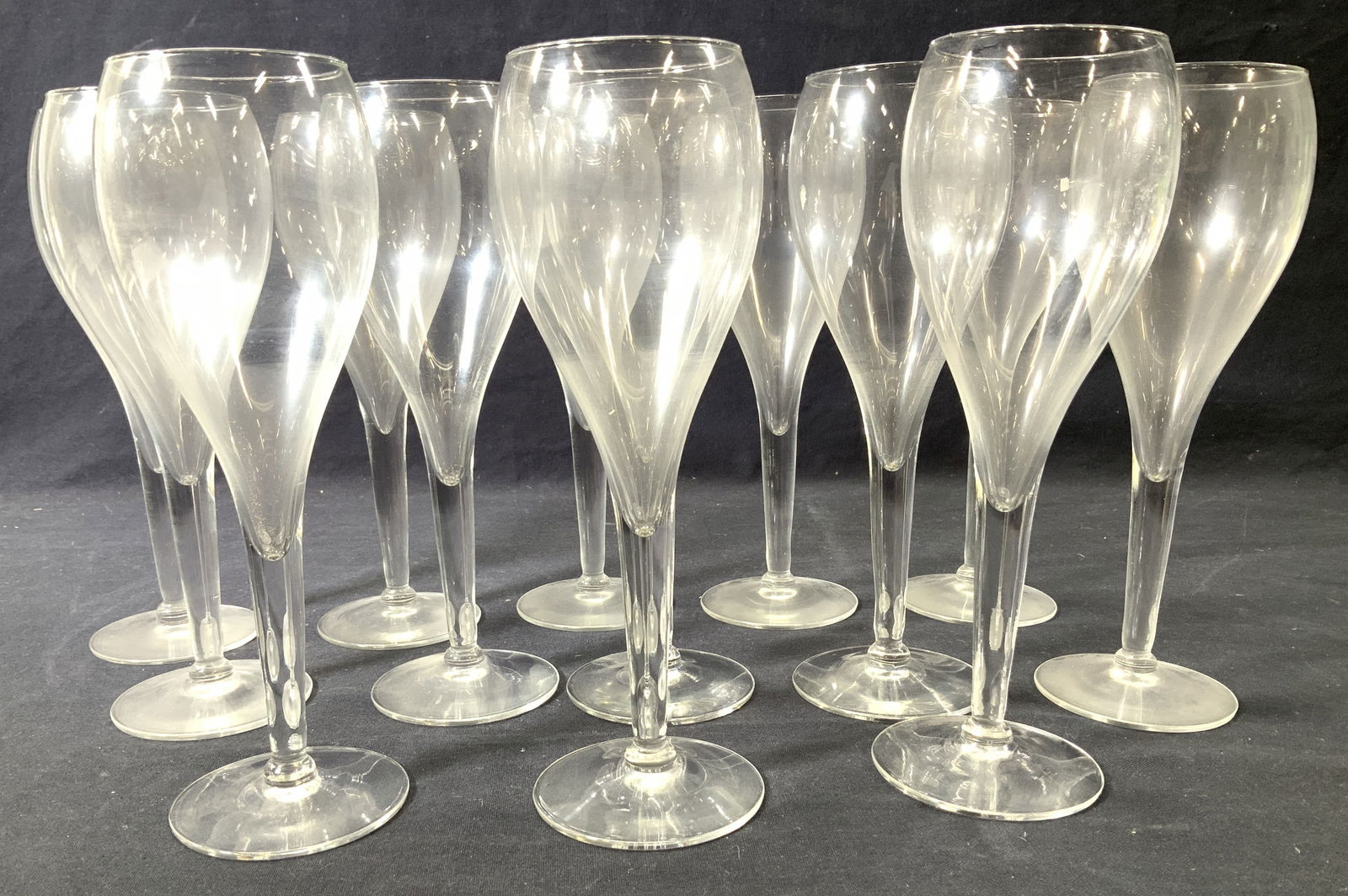 Set 13 Hand Blown Glass Stemware: Set 13 vintage hand blown glass stemware with tulips shape goblet. 8.5 x 3 in. Thick stem, smoothed pontil on verso. Round base measures 2.75 in. Diameter. Property of 5th Avenue, Manhattan, NY estate