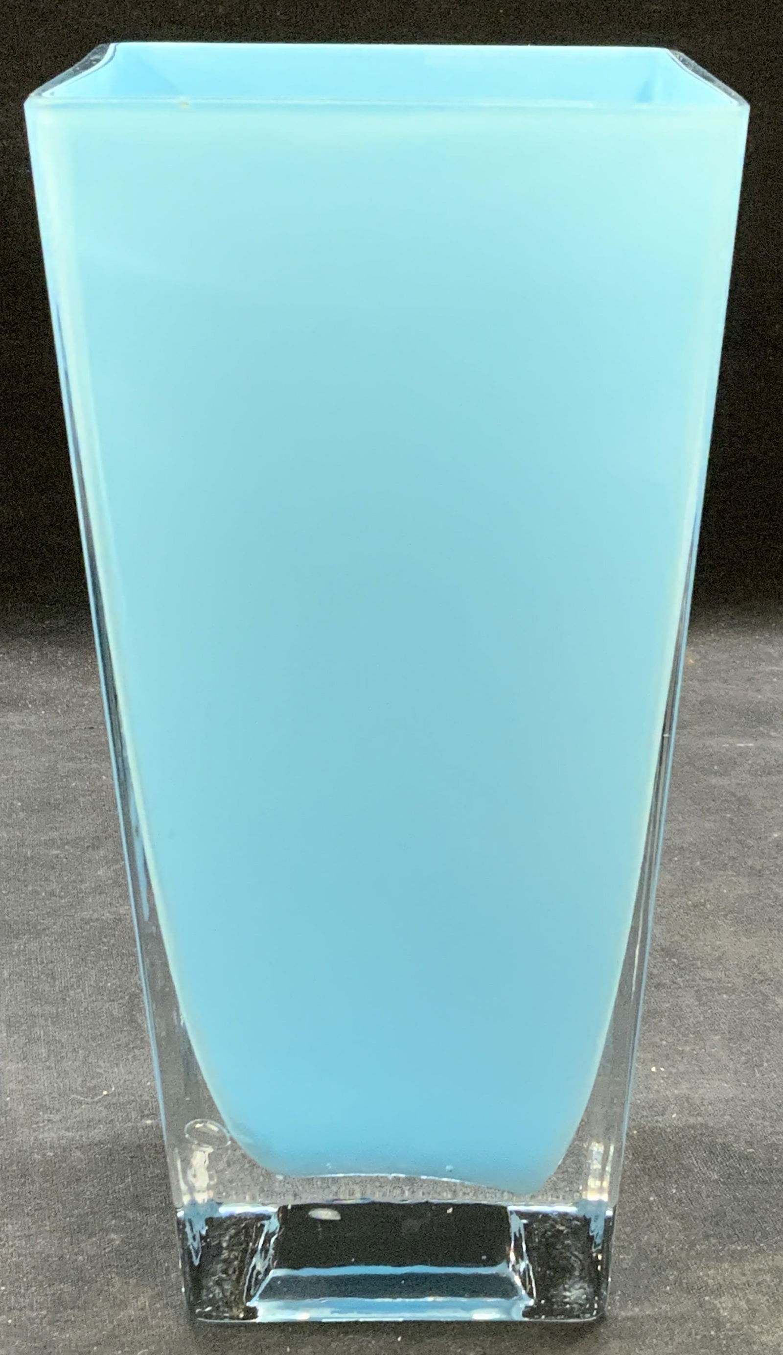 Sky Blue Square Glass Vase: Sky blue toned square glass vase. Some surface wear consistent with exposure. Measures approx. 3 7/8 x 3 7/8 x 7 7/8 inches. Vase, glass vase, blue vase, table decor, table accessories, home decor, ho
