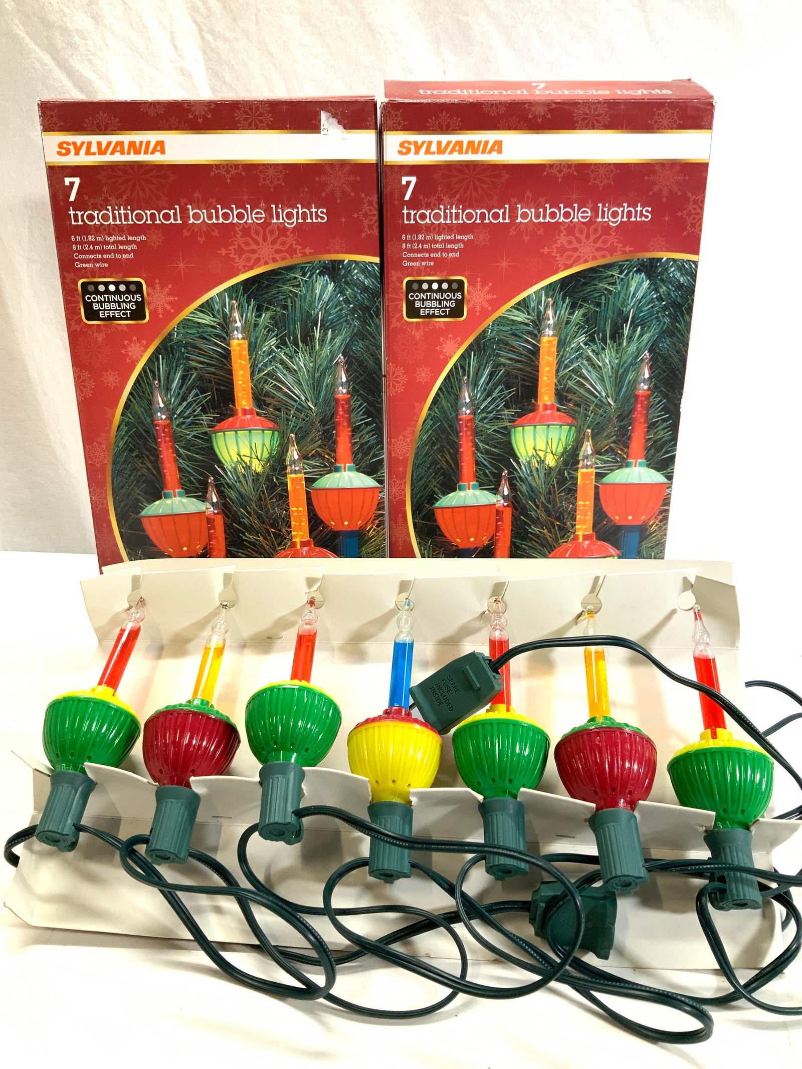 4 Boxes Indoor Christmas Bubble Lights: 4 boxes of Christmas Bubble Lights on green cord. Each light measures 5.25 in. Tall. Some liquid in the bubble tube are clear and some are colored. 1 strand has 6 lights. 3 other strands have 7 lights