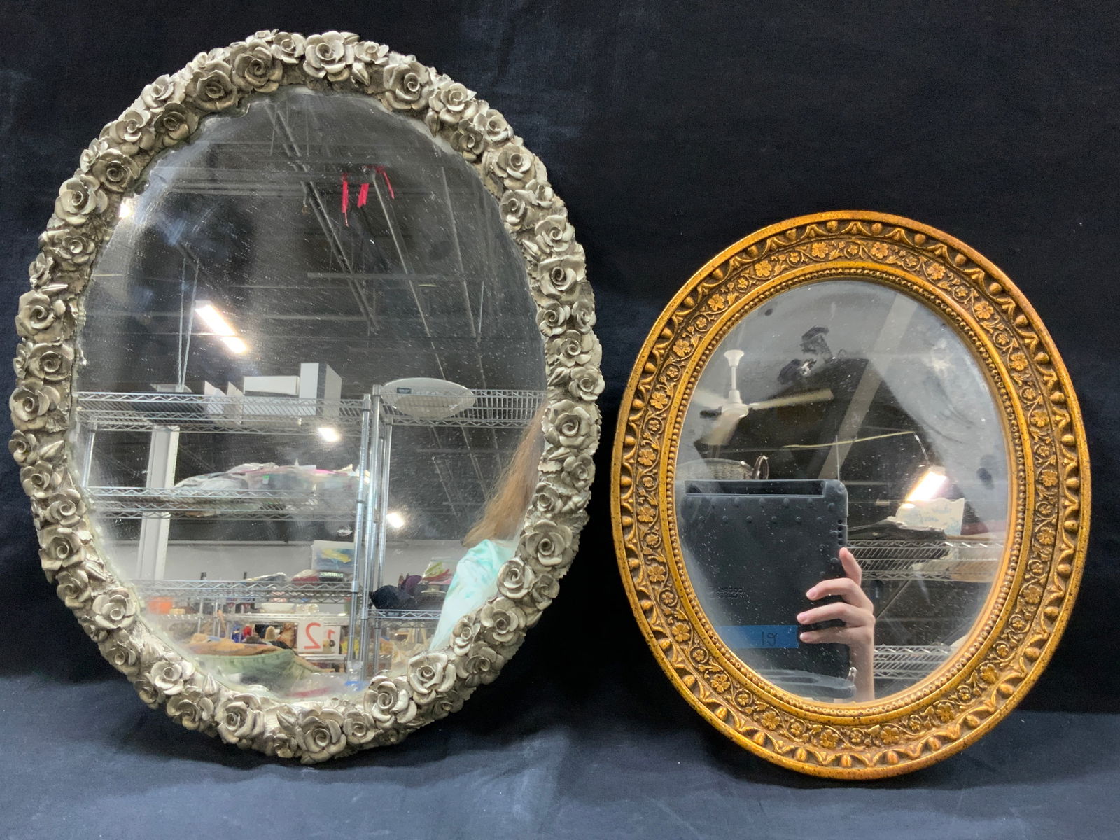 2 Wooden & Metal Wall & Table Mirrors: Set of 2 mirrors. 1 with metal frame with raised rose design with underside having feet to be places on a table and 1 gold painted carved wooden framed wall mirror. Table mirror is approximately 16 x