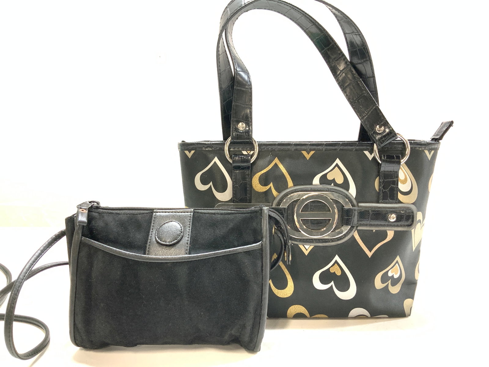 Black Suede Crossbody, Heart Motif Handbag, 2: Man made leather heart motif black handbag , zippered closure, handle drop 6.5 in. 1 interior zipper pouch. Measures 11 x 7 in. Black leather and suede crossbody purse , zipper closure , exterior pouc
