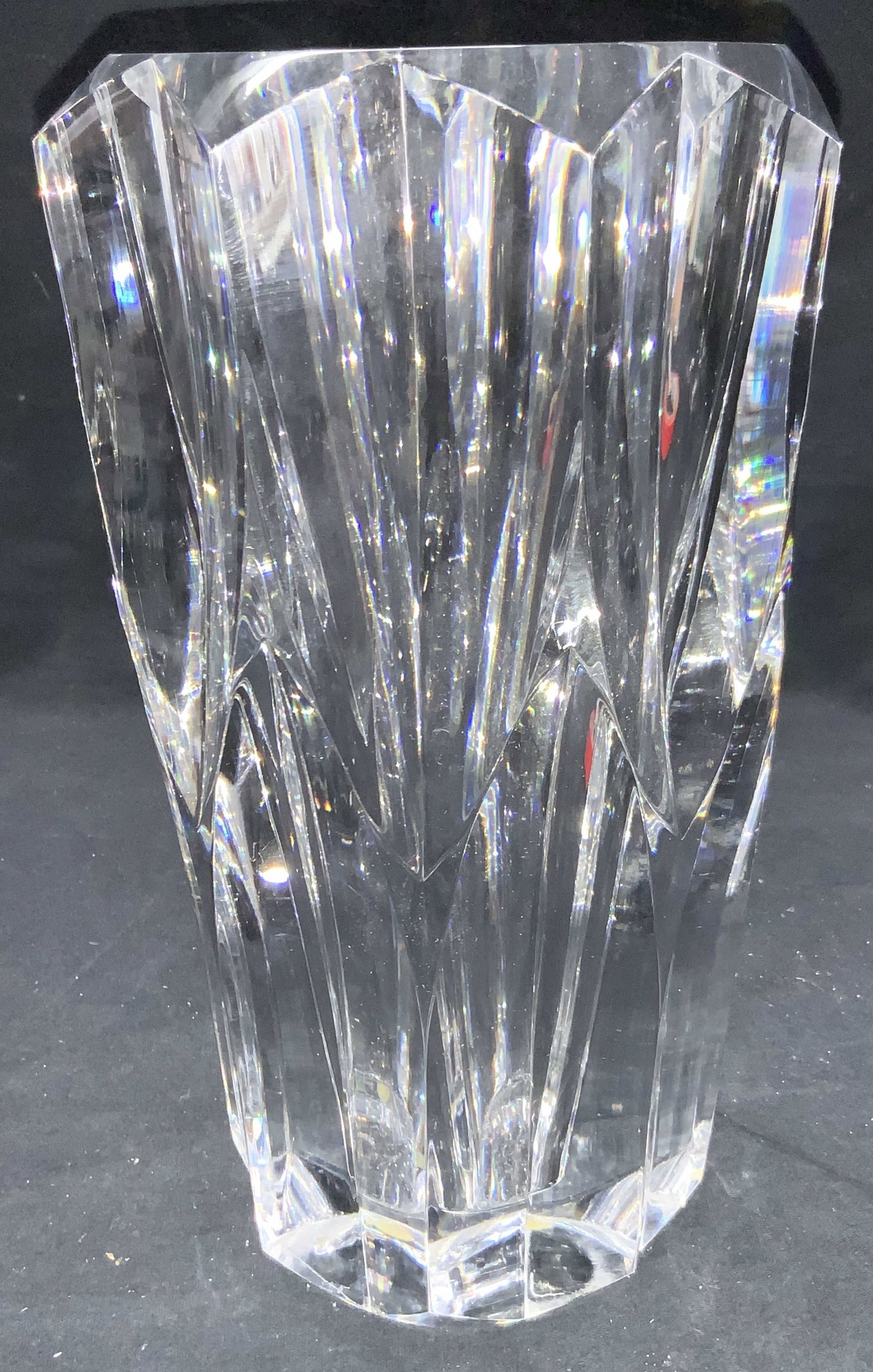 Thick Walled Cut Crystal Vase: Thick walled cut crystal vase, weighted Exterior has faceted cuts with a large saw tooth edge. Approximately 10 inches tall and 4.75 inch diameter, Minor surface wearing. Crystal vase. Thick walled cr