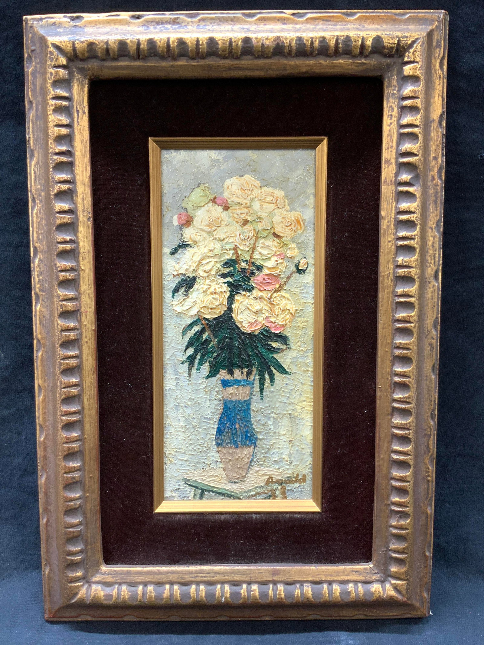 Arnold Signed Still Life Oil Painting: Signed on lower right corner, possibly reads Arnold, 78 Depicts a bouquet of white roses in a blue vase made with layers of paint. Framed in golf metal leafed wooden carved frame with felt inner panel