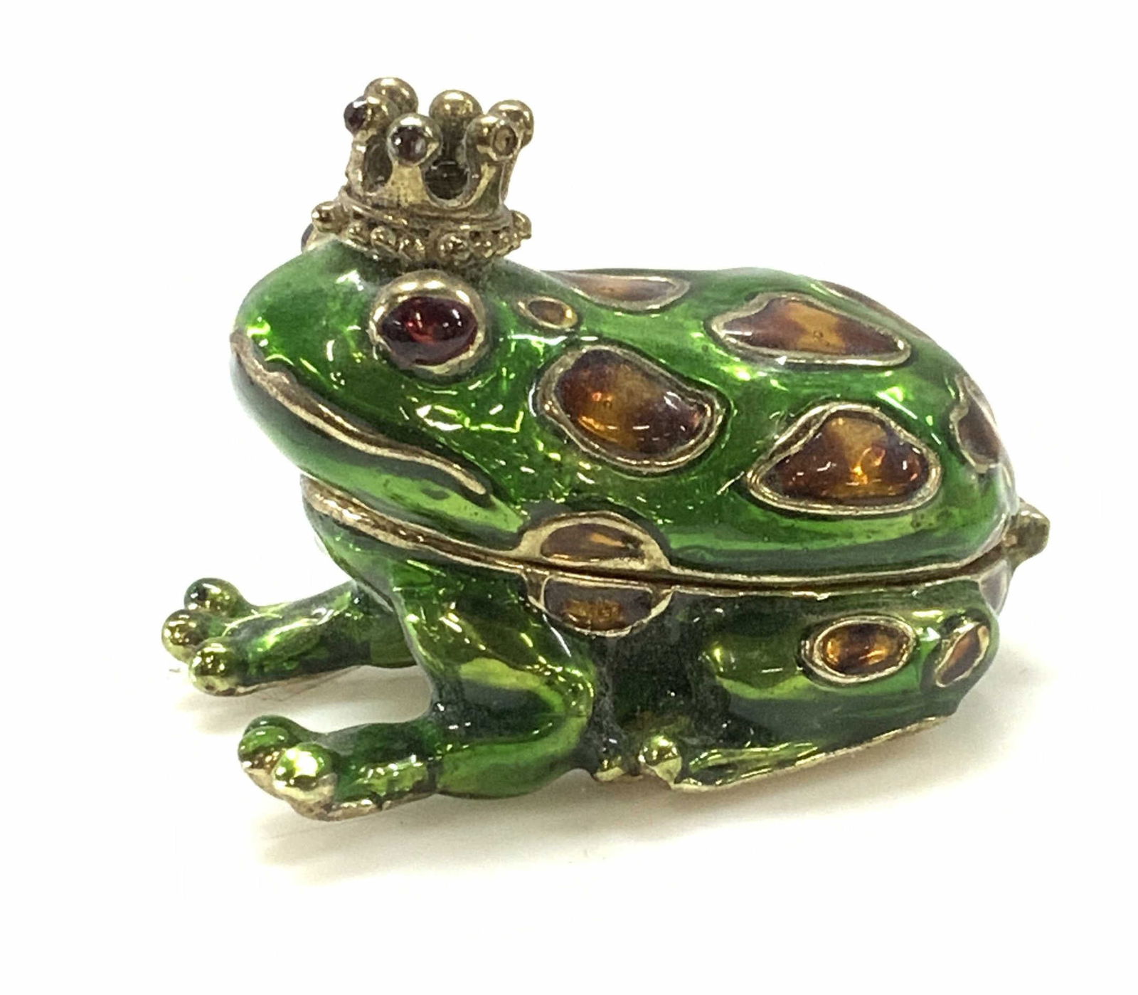 MONET Enamel Prince Charming Frog Pill Box: Vintage Money green and amber enamel ‘Prince charming ‘ frog with crown on its head. Magnetic closure. Hinged open revealing aqua blue enamel. Signed Monet on underside. 2.5 x 1.5 in. Monet pill b