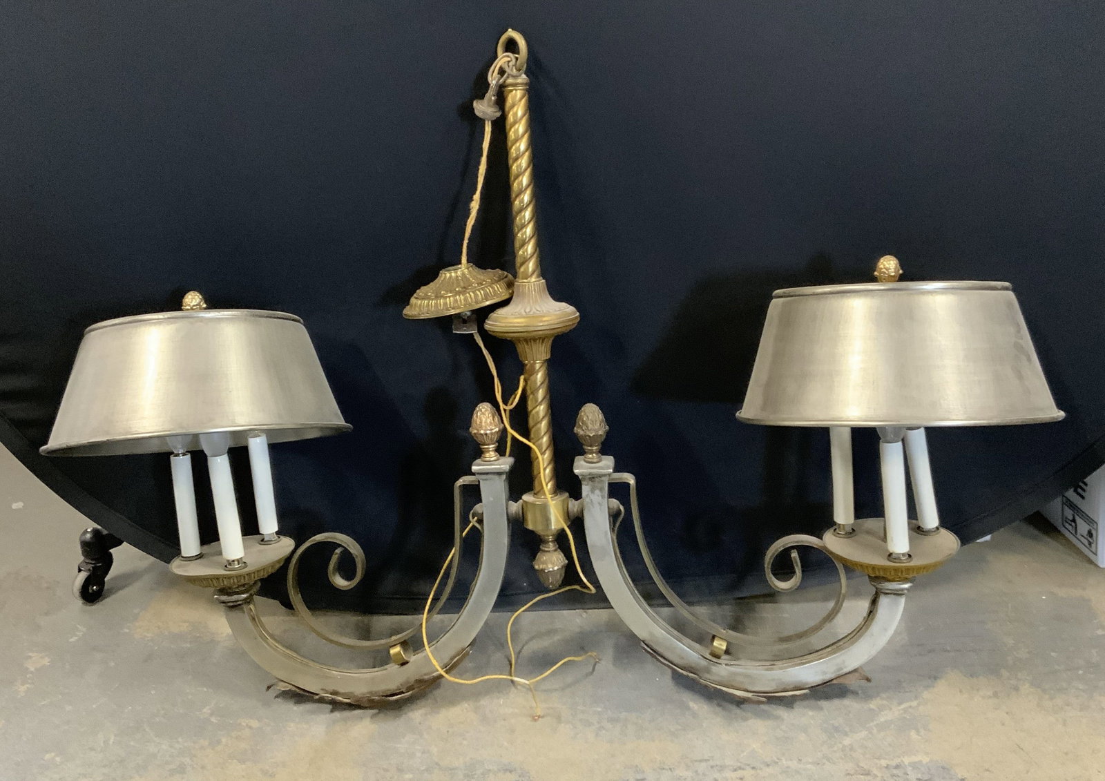 Metal Scroll Two Arm Chandelier: Silver tone metal scroll chandelier with two arms. Not tested for function. Surface wear consistent with exposure. Measures approx. 33 x 5.25 x 29 inches. Shades measure approx. 12 inches wide. Chande
