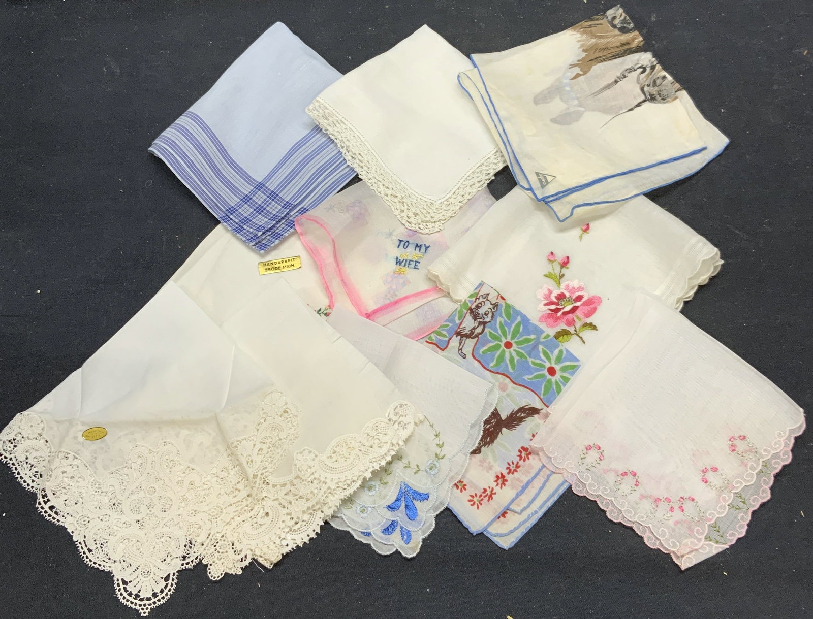 Group Lot Vintage Cotton Handkerchiefs: Group of 11 vintage cotton handkerchiefs with lace, embroidery, and printed decoration. Some pieces marked handmade. Some pieces new. All pieces have some wear to material consistent with exposure. In