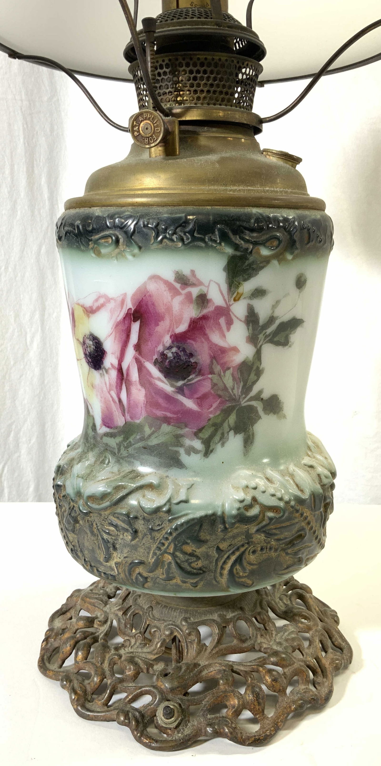 B&H Glass & Metal Gone With The Wind Lamp: Lamp reads B&H. Lamp is vintage possibly antique. Piece has metal base with ornate and pierced detail. Some elements may be hand painted with multi toned floral & leaf detail. Includes white toned gla