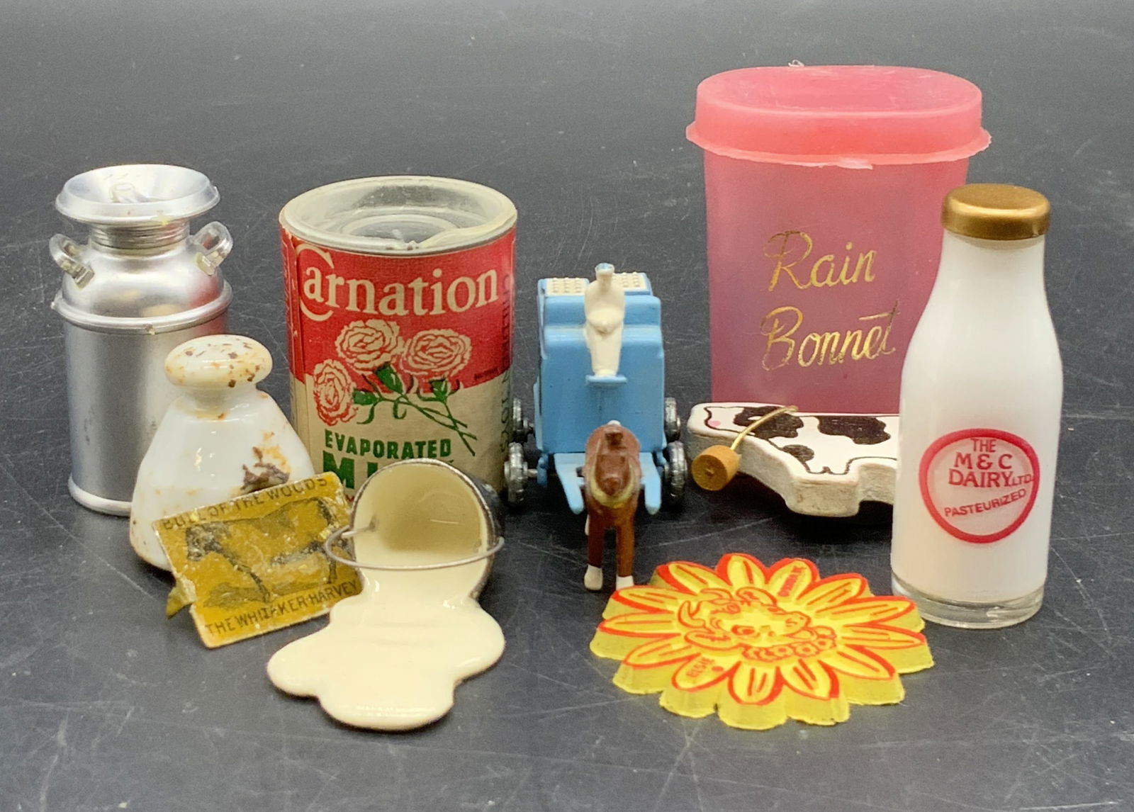 Grp Lot Vintage Collectible Figurals, Cows & More: A group lot of vintage collectible figurals. Group includes a 1988 Matchbox milk wagon, cow magnet, a carnation milk toy figural, a BORDENS ELSIE collectible, a milk can, and more. Pieces are crafted