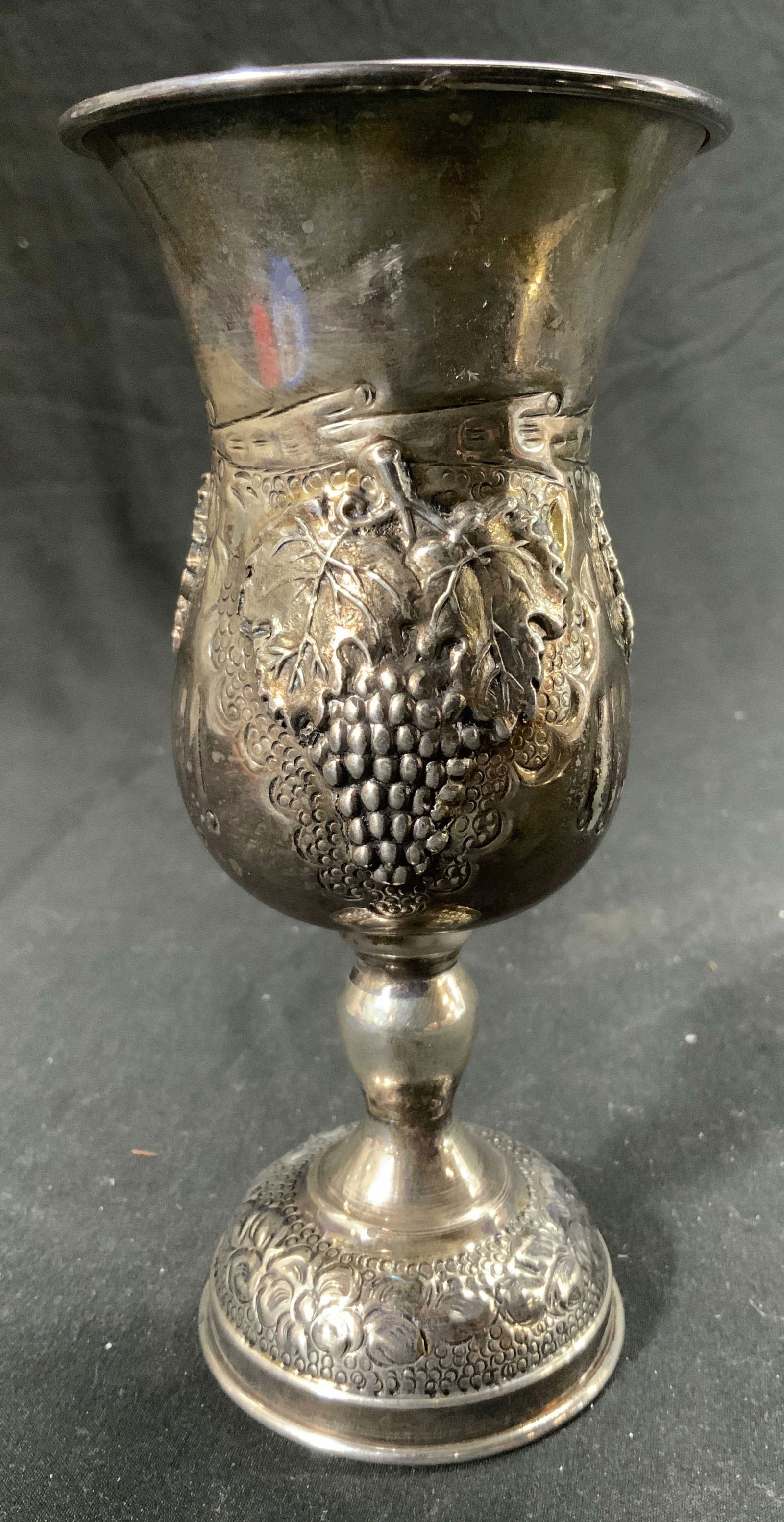 Sterling Silver Vintage Goblet Vessel: Base is inscribed 925. Goblet is sterling silver. Piece has grape & leaf detail. Measures approx 6 inches tall 3 inches wide. Weighs approx 3.58 OZT. Vessel, goblet, sterling silver, sterling silver g