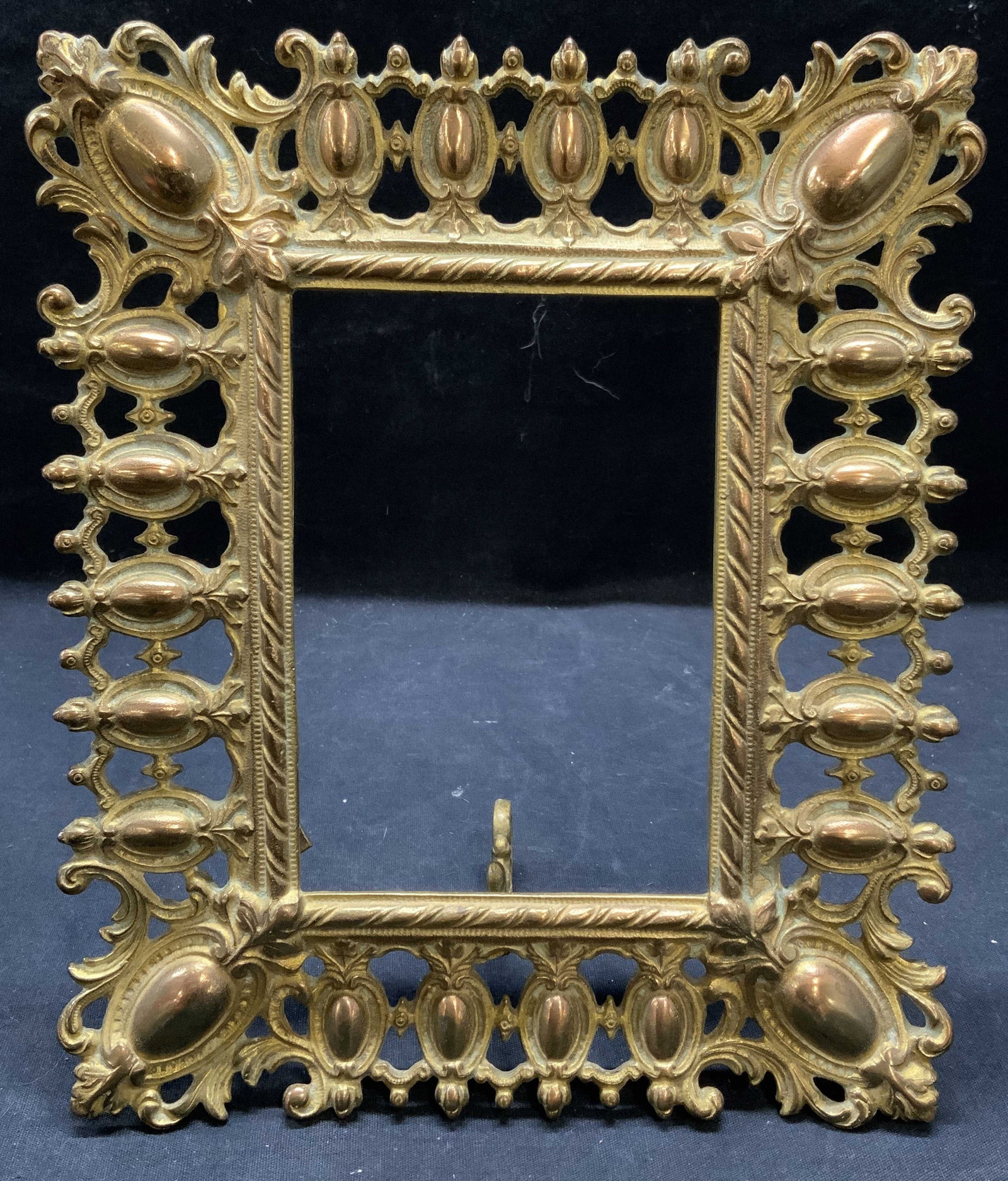 Vintage Brass Rectangle Scroll Frame: Vintage brass rectangle shaped frame with scroll border. Surface wear consistent with exposure. Measures approx. 9.5 x 8 inches. Piece has weight. Frame, brass frame, scroll frame, rectangle frame, ta