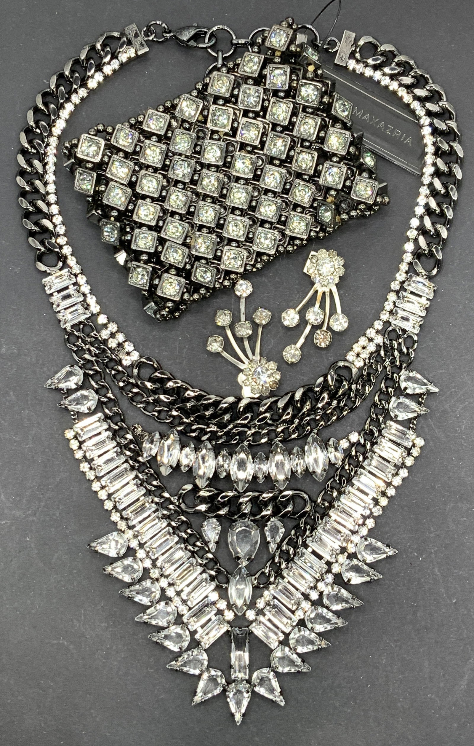 4 BCBG MAXAZRIA Rhinestone Necklace, NWT more: Heavy cocktail necklace by BCBG MAXAZRIA with felt pouch. Necklace is in gunmetal with clear rhinestone with a triangular bib 12 in. L adjustable. Bib measures 5 x 4 in. Glittery crystal stretch brace