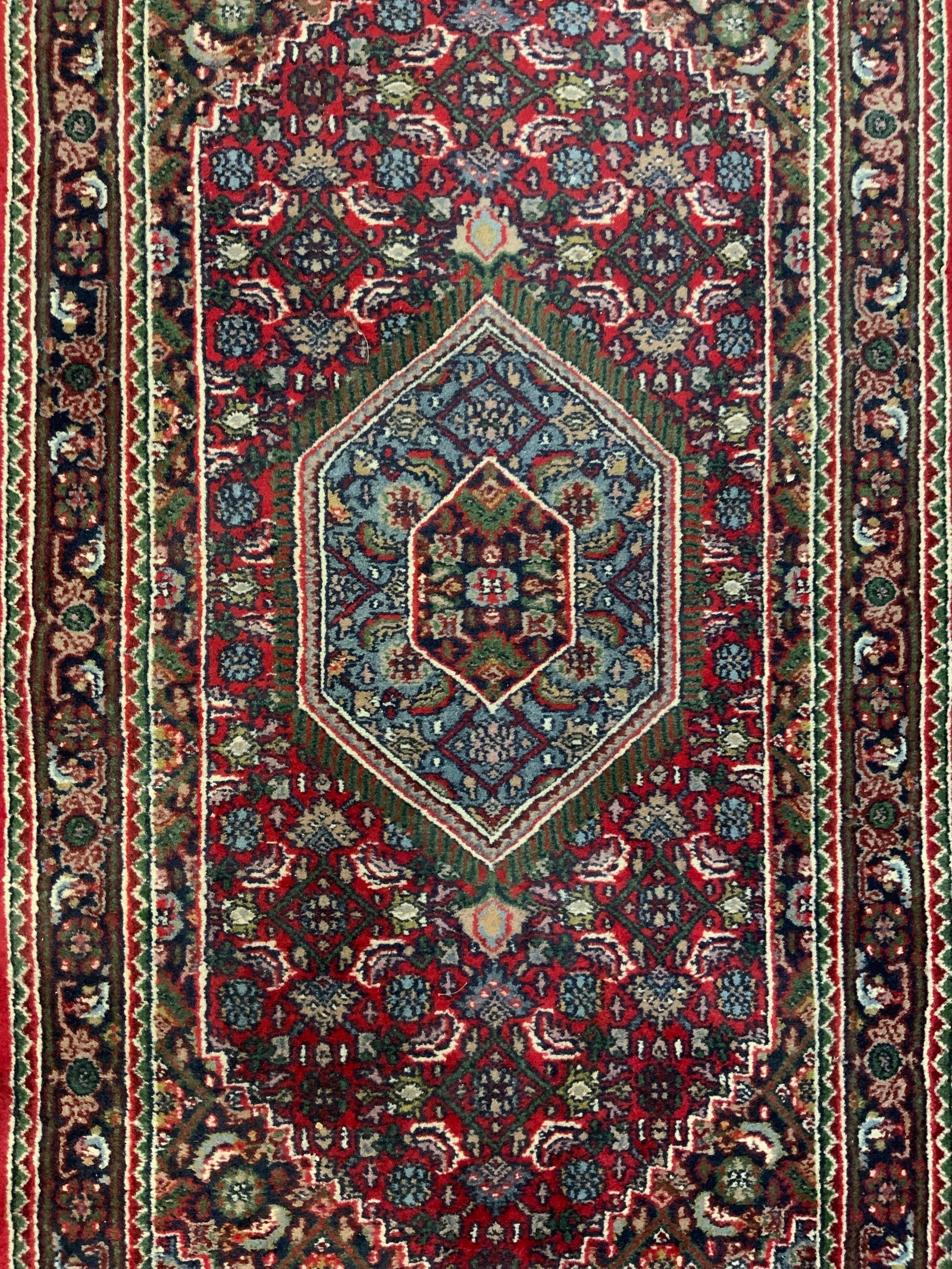 Vintage Handmade Persian Wool Area Rug: Rug is handmade and wool. Piece is Persian. Rug is vintage possibly antique. Rug has cream toned fringes at edges. Rug has intricate multi toned floral & geometric detail. Piece measures approx 67 inc