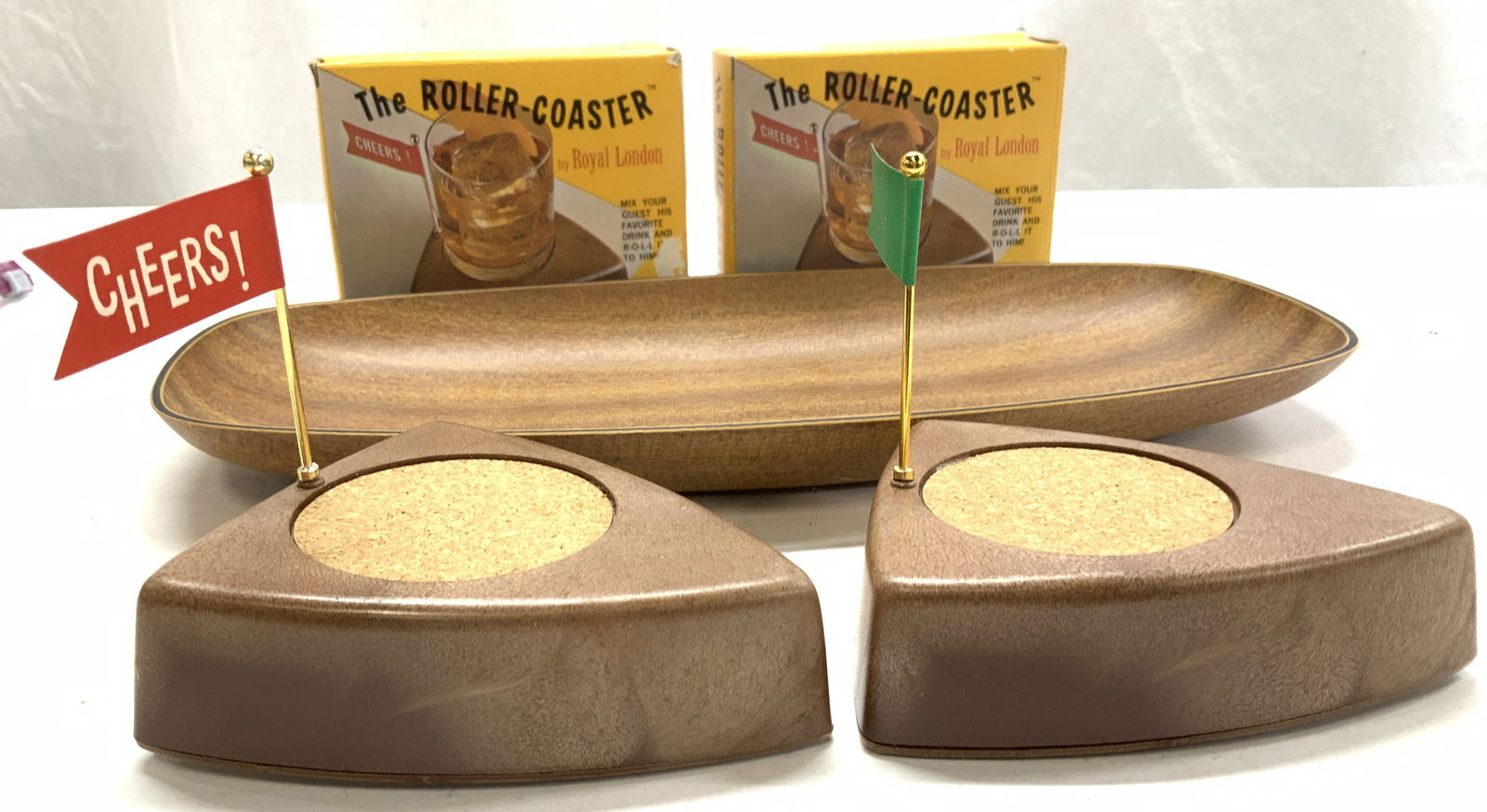 MCM Wind Up Golf Roller Coasters and Tray, 3: The Roller Coaster by Royal LONDON, c. 1969 in original box. Wind up gold motif putting ‘ green plastic and cork drink coaster that rolls on wheels. Mechanism will need repair and can be unscrewed o