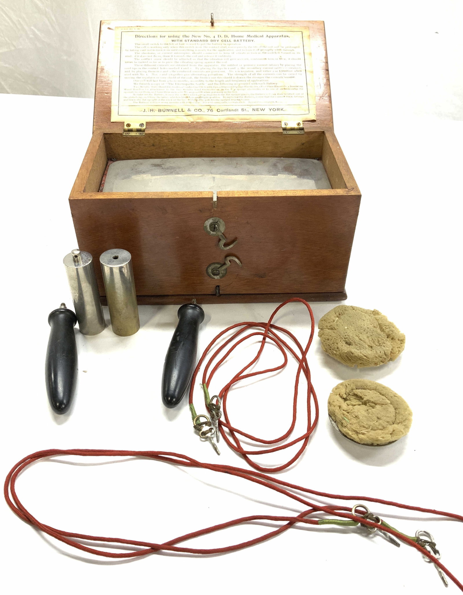 Antique JH Bunnel & Co Medical Apparatus: Home Medical Apparatus, Manufacturer:J.H. Bunnell & Co. – New York. Manufactured from:1890-1920. Home Medical Apparatus with standard dry cell battery in a wooden box with hook latches and carry han