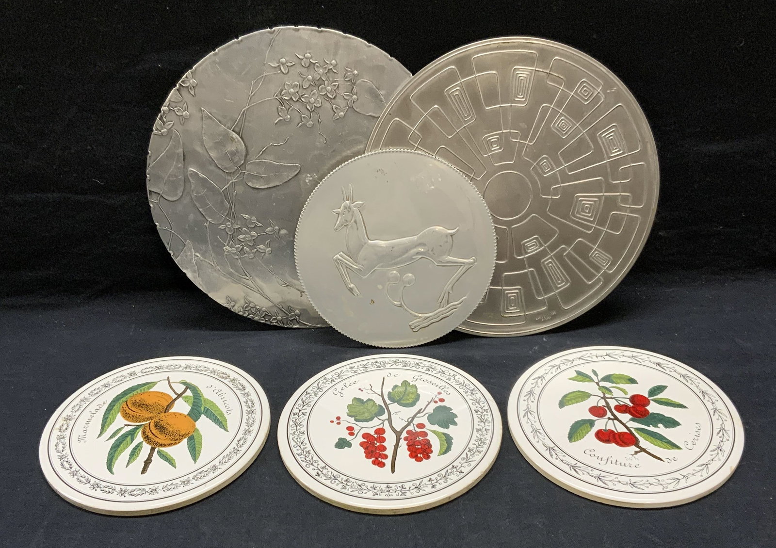 Lot 6 Gabis Stainless Steel Trivet, More: Lot of 6 stainless steel and ceramic trivets. Gabis Sweden stainless steel trivet with geometric pattern, measures approx. 8 5/8 inches diameter. Trademarked along edge. Stainless steel trivet with de