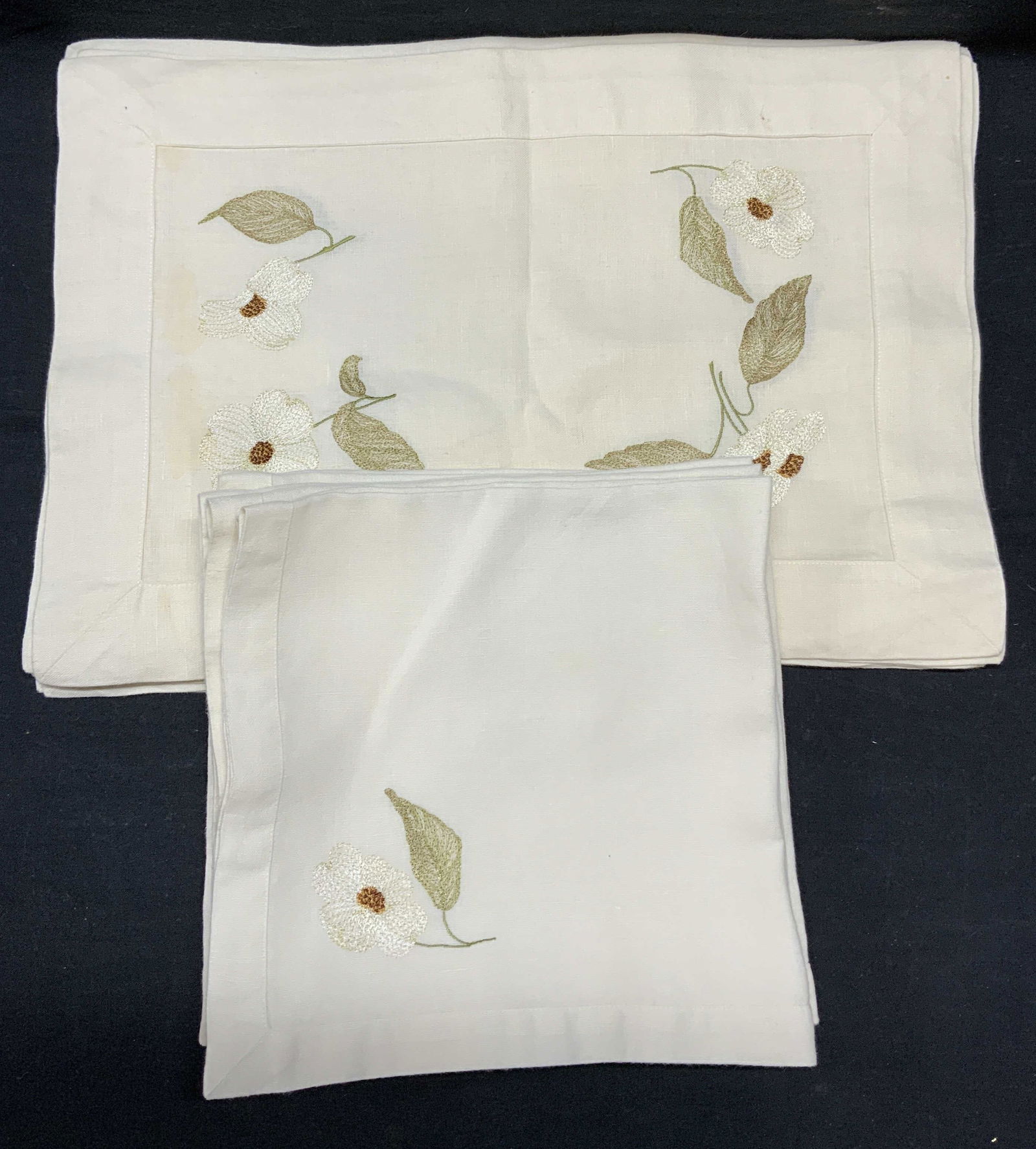 Set 16 Linen Placemats & Napkins: Set of 16 linen placemats and napkins with embroidered floral motif. 8 Placemats measure approx. 19 x 13 inches each. 8 Napkins measure approx. 22 x 22 inches each. All pieces have some wear including