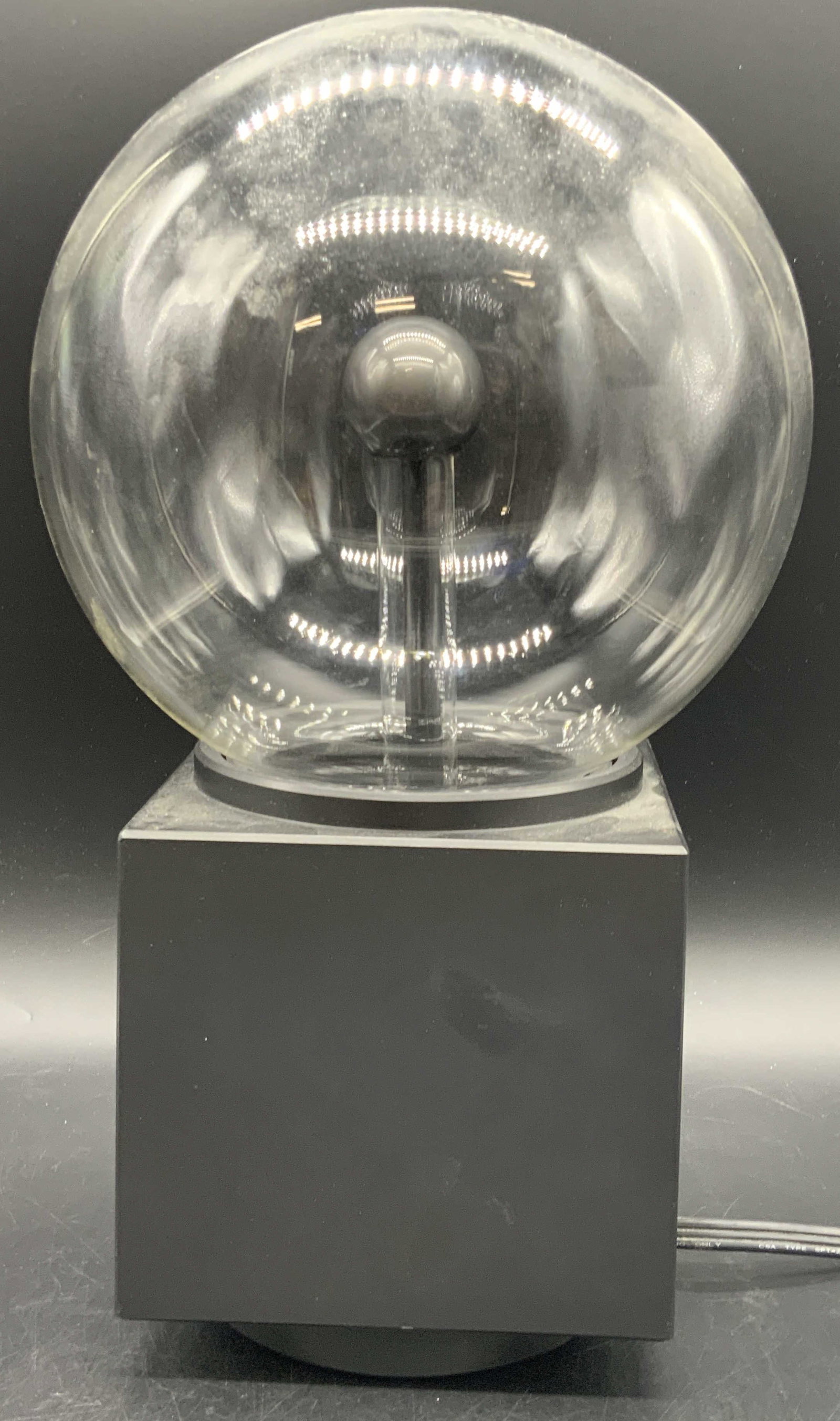 EYE OF THE STORM Plasma Lightening Globe Light: A EYE OF THE STORM Plasma Lightening Globe Light. Clear globe from top, black base & cord. Buttons to obverse. Serial number to underside reads 305442. Date of manufacturing reads 8746. Measures appro