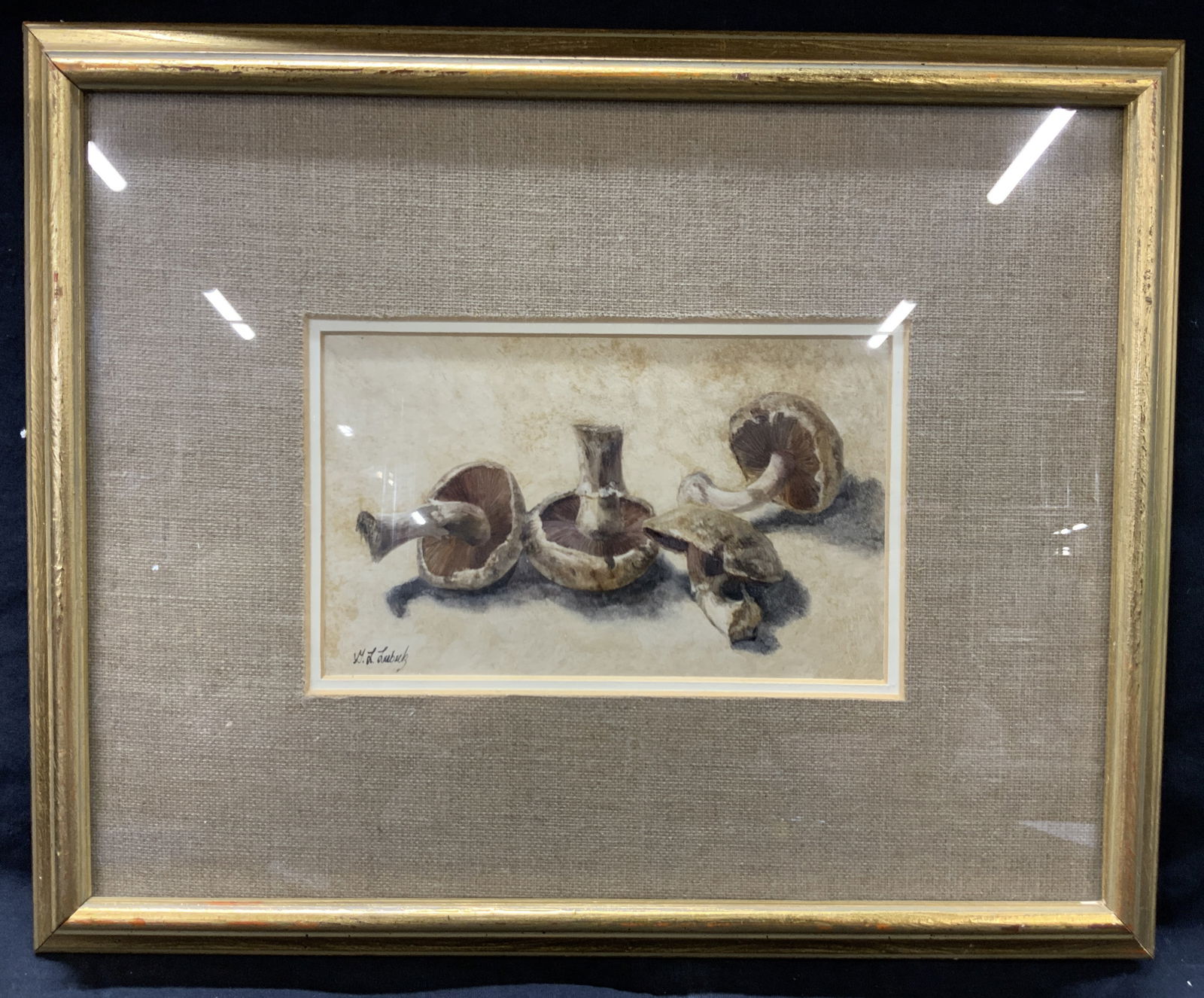 Signed Lubuck Mushroom Acrylic Painting: Signed on lower left corner, possibly M.J.Lubuck Depicts four mushrooms on a table. Framed in gold metal leafed wooden frame with linen mat board. Approximately 13 x16 inches window measures 4.5 x 7.5