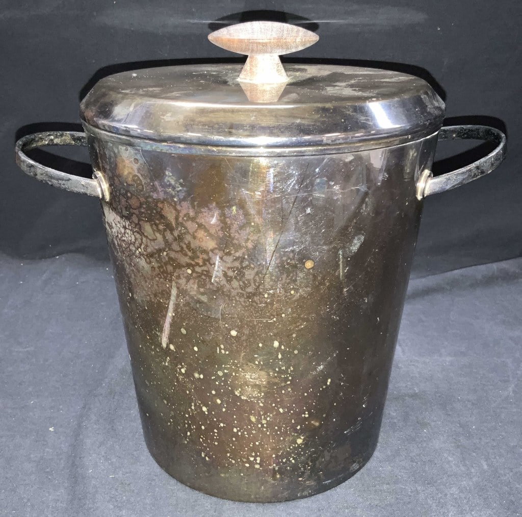 Vintage EL Silver plate Ice Bucket, Italy: Vintage silver plate ice bucket with wooden knob handle for lid and side handles, has insulated interior in black. Marked EL made in Italy on underside. Approximately 10 inches tall and 7 inch diamete