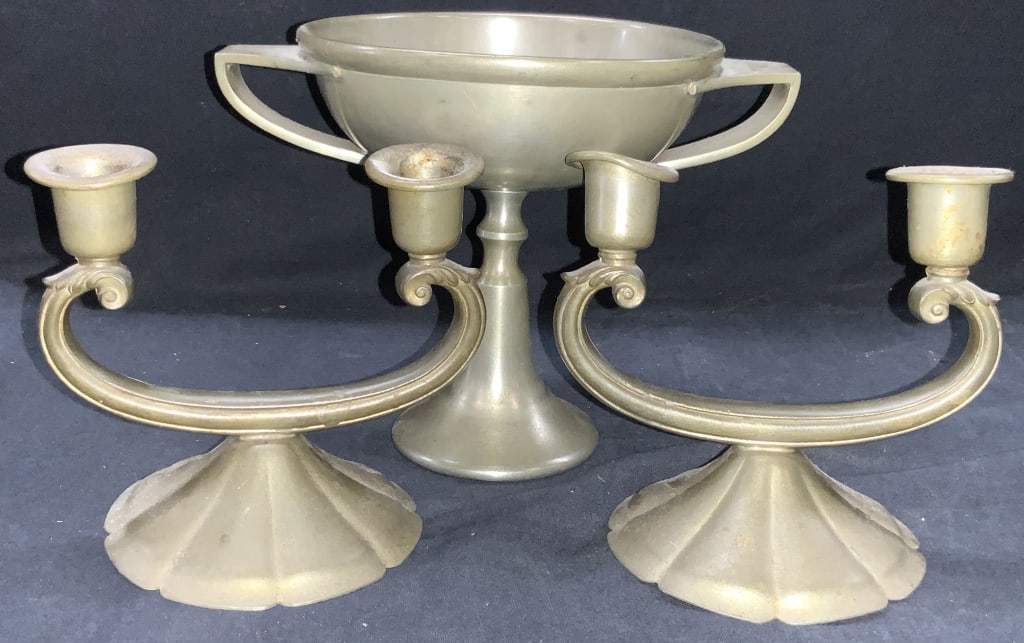 3 Mayflower & New Amsterdam PewterWare: Lot of 3 pewter made table accessories. 1 footed goblet, Marked Mayflower Pewter, approx 5.5 inches tall and 7,75 inch diameter. Set of 2 New Amsterdam silver co. pewter candle holders. Approximately