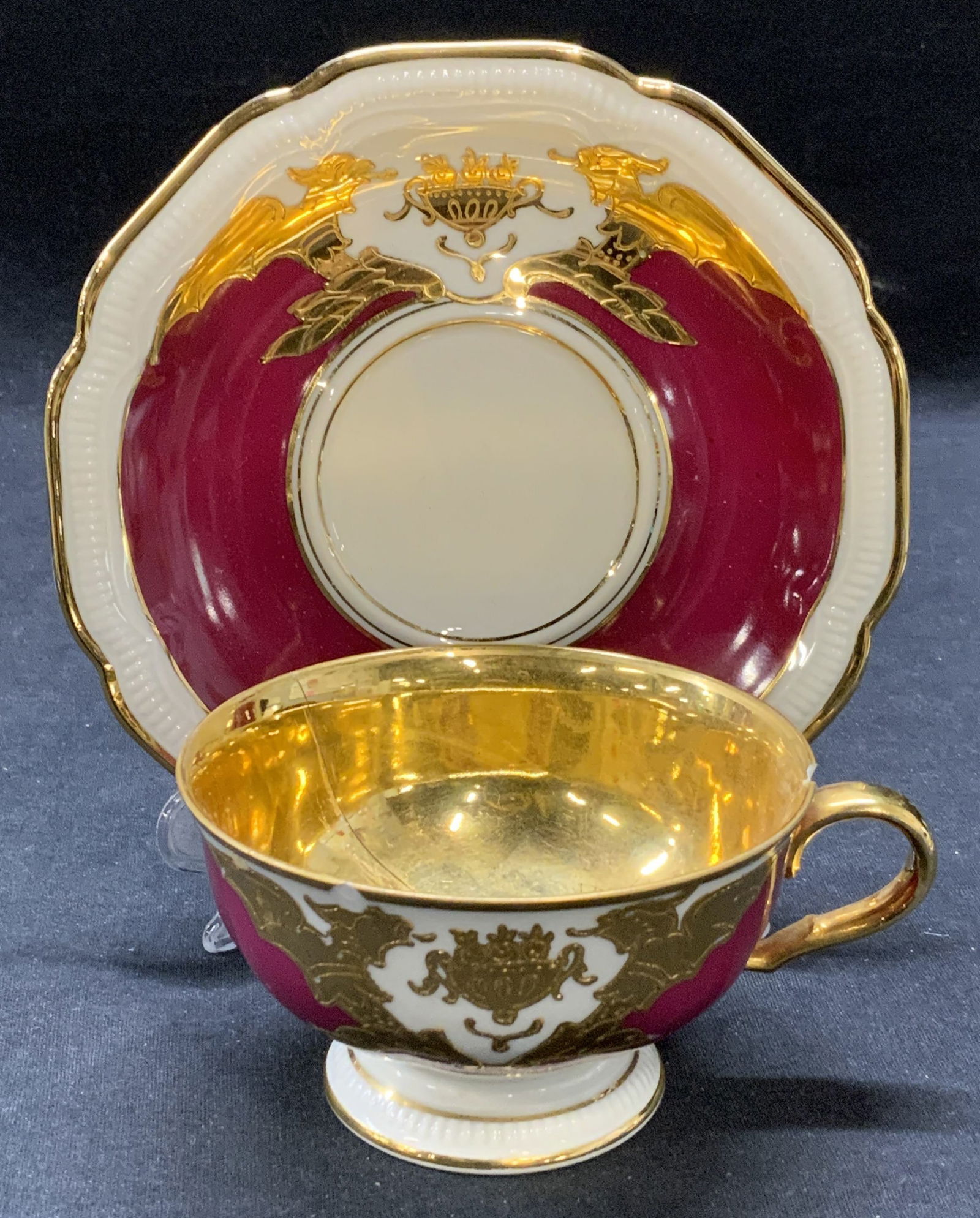 HUTSCHENREUTHER Gilt Porcelain Teacup & Saucer: Vintage HUTSCHENREUTHER gilt porcelain teacup and saucer. Previous repair to teacup. Both pieces trademarked to undersides. Made in Germany. Saucer measures approx. 6 inches diameter. Teacup measures