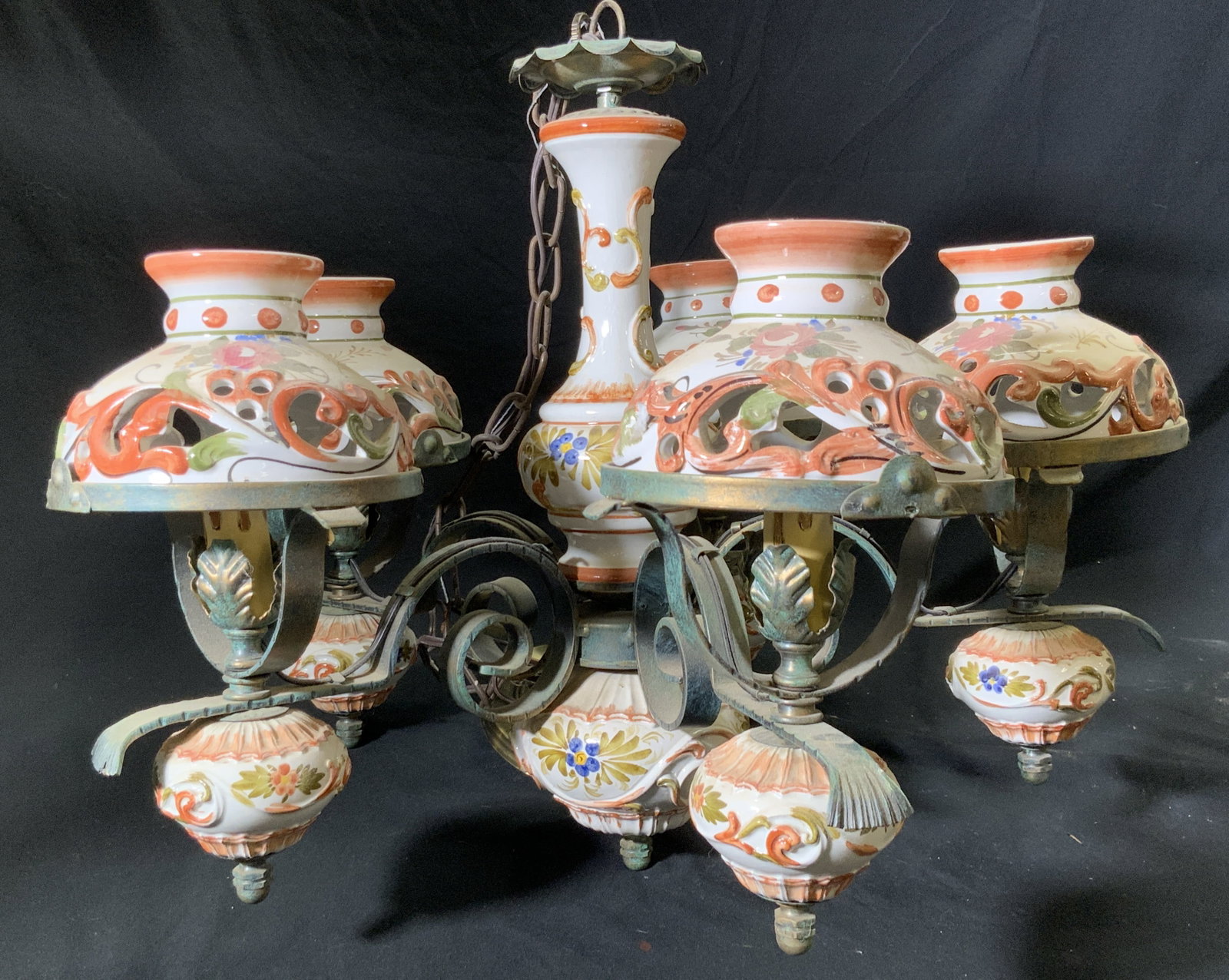 Vintage Hand Painted Ceramic & Bronze Chandelier: Vintage hand painted ceramic and metal, possibly bronze, chandelier. Curled metalwork and pierced ceramic designs throughout. Florals and foliage motifs to the ceramics. Measures approx. 44H x 20W in.