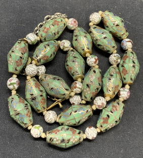 Asian Cloisonne Beaded Necklace, Jewelry: Asian cloisonne beaded necklace, enamel and gilt decorated brass beads with floral motif. Some surface wear consistent with exposure. Measures approx. 23 inches long excluding extension chain. Estate