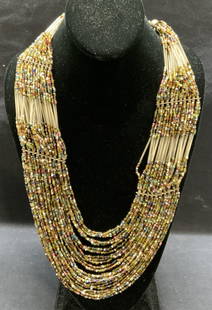 Multi Strand Seed Bead Necklace, Jewelry: Multi strand multi color seed beaded necklace. Measures approx. 25 inches long. Some surface wear consistent with exposure. Estate jewelry, costume jewelry, cocktail jewelry, fashion jewelry, accessor