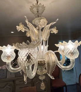 Mazzuccato Murano Art Glass Gold Fleck Chandelier: Purchased in Murano Italy. A Venetian vintage hand blown Mazzuccato Murano art glass gold fleck floral chandelier. Clear art glass featuring gold flecks & swirls. Daffodil and leaf / plumes forms. Rib