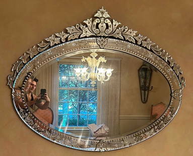 XL Antique Venetian Glass Oval Wall Mirror: A vintage, possibly antique, extra large ornately decorated Venetian glass wall mirror. Measures approx. 45.5L x 56.5W in. Raised cut glass beads and etched florals throughout. Oval form. Reverse is w