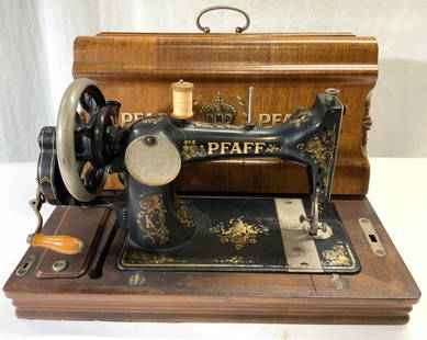 GM PFAFF Antique Sewing Machine: Machine reads GM PFAFF KAISERSLAUTERN. Piece is antique serial no 1089747. PIece is black and gold toned & metal with wooden base. Piece includes key. Machine includes painted cover which reads PFAFF