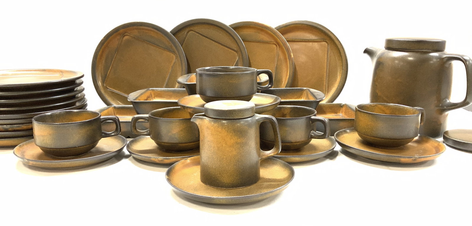 Rustic KW Eathenware Modern Tableware, 35: Signed rustic modern tableware , matte orange-brown pottery, impressed manufacturer’s symbol, and, on some pieces marked ‘KW’. 35 pieces total Teapot with lid and creamer with lid. Teapot measur