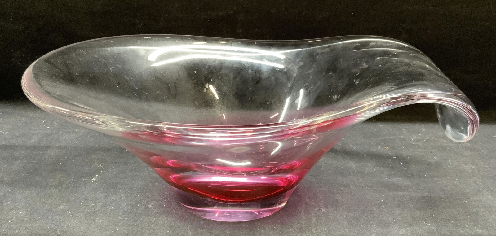 Flygsfors Coquille Art Glass Bowl, Sweden: Flygsfors Coquille Art glass bowl in clear to pink. Signed to underside. Made in Sweden. Thick walled glass. Piece has weight. Some surface wear consistent with exposure. Measures approx. 13 x 8.5 x 4