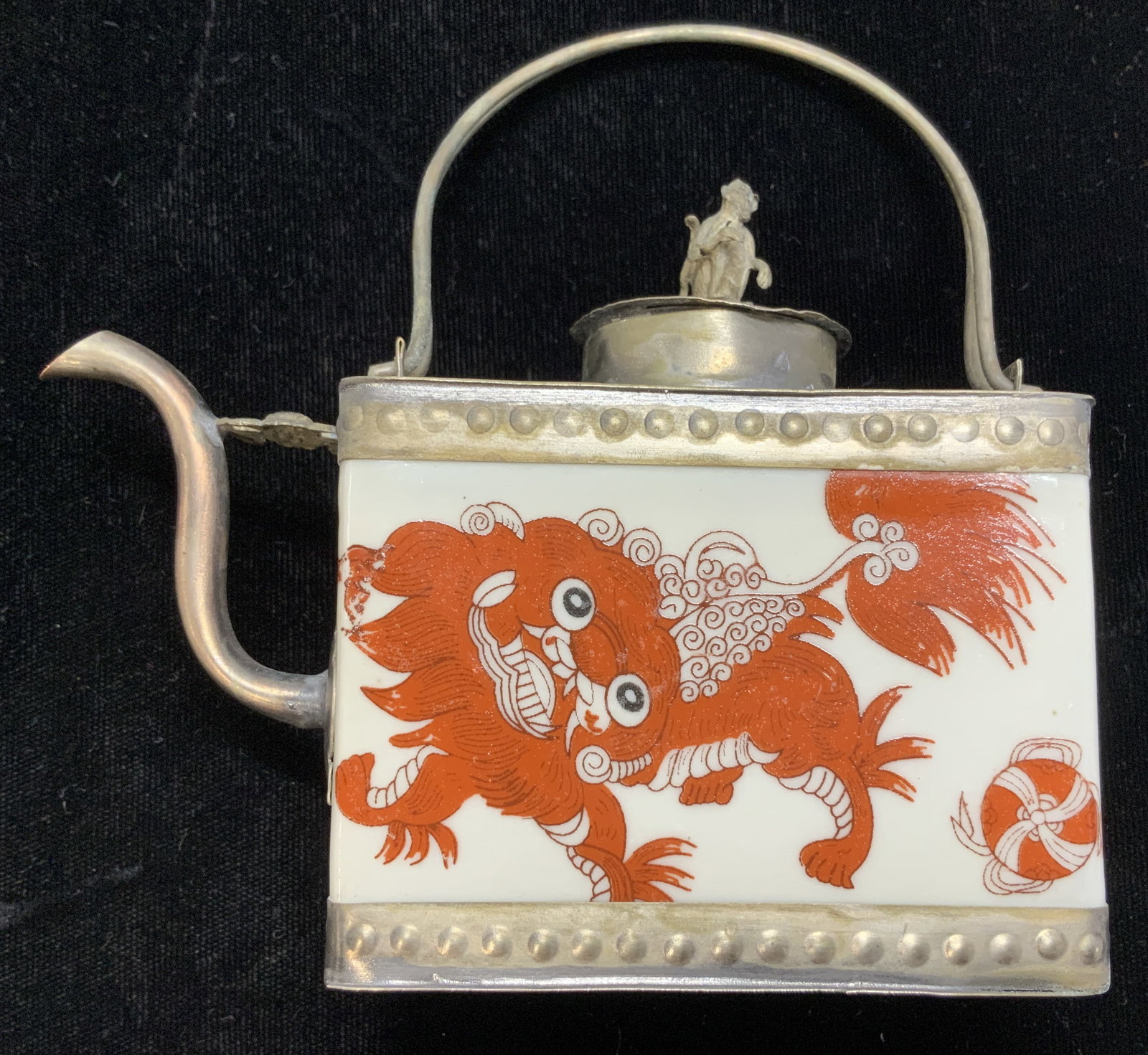Asian Shi Shi Tibet Silver & Porcelain Tea Pot: Hand painted white porcelain tea pot with orange shi shi/ lion temple dog on both side. Hand crafted and encased by Tibetan silver toned metal with filigree butterfly, Chinese dragon, bat, and monkey 