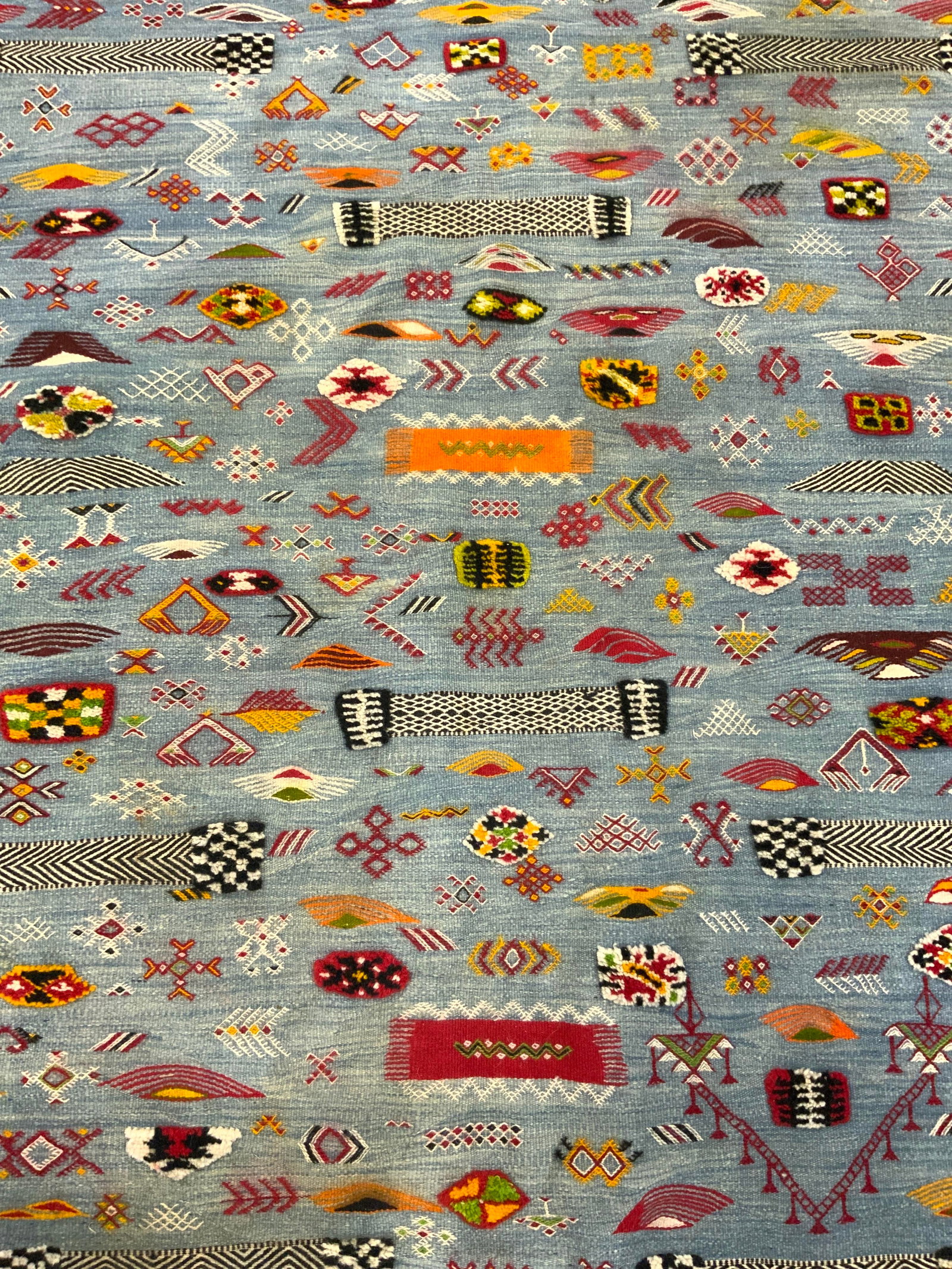 Vintage Tribal Style Handmade Wool Rug: Rug is handmade and wool. Piece has intricate multi toned geometric tribal style detail. One side of rug has fringes. Some areas have raised detail. Rug measures approx 100 inches long 72 inches wide.