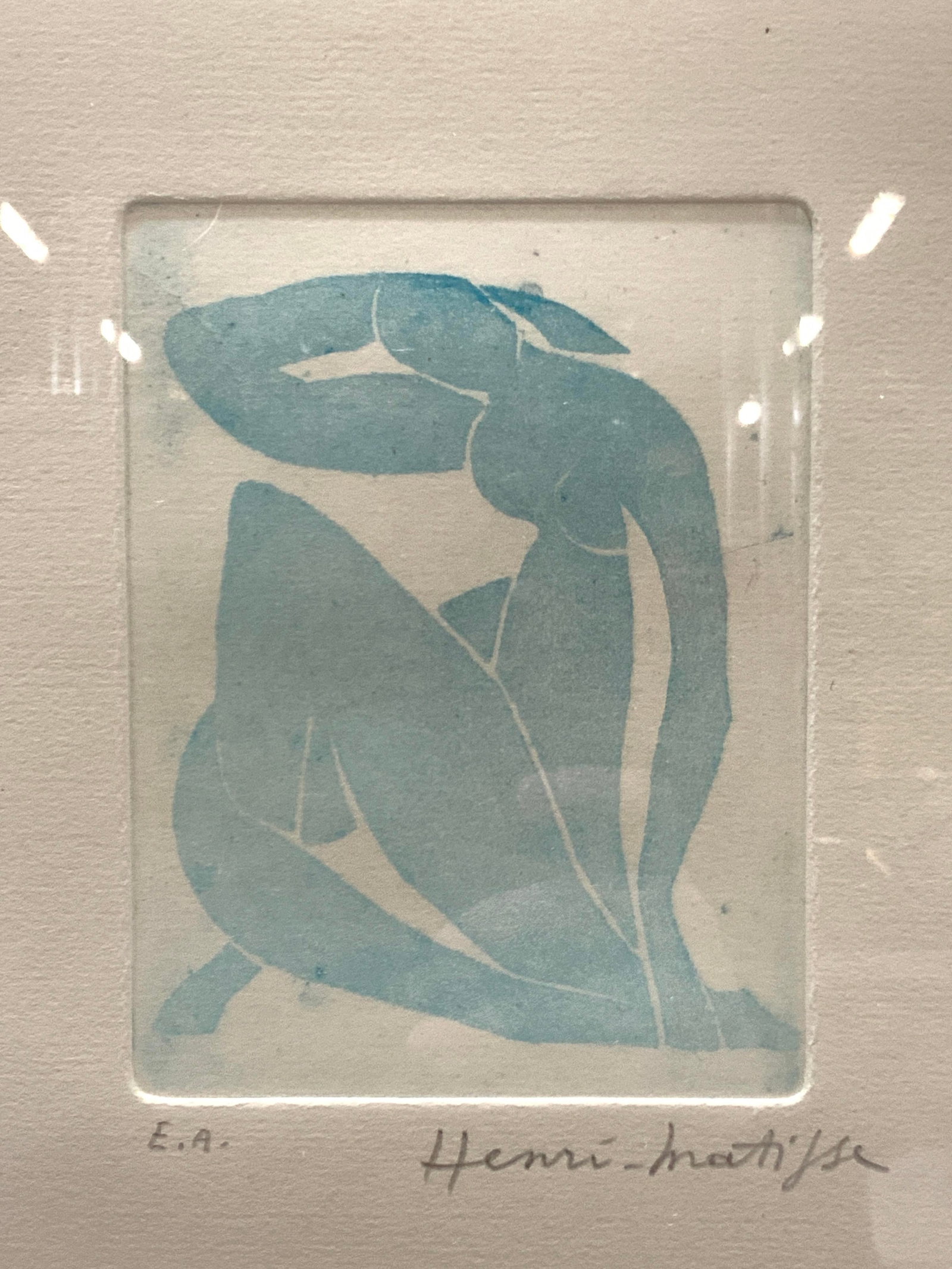 ATTR Matisse Signed Blue Nude Lino Cut: Signed in lower right corner in graphite, Henri Matisse, E.A Subject depicts a blue nude female figure in a contoured position Framed in copper toned wooden frame with leaf motifs on edges and floated