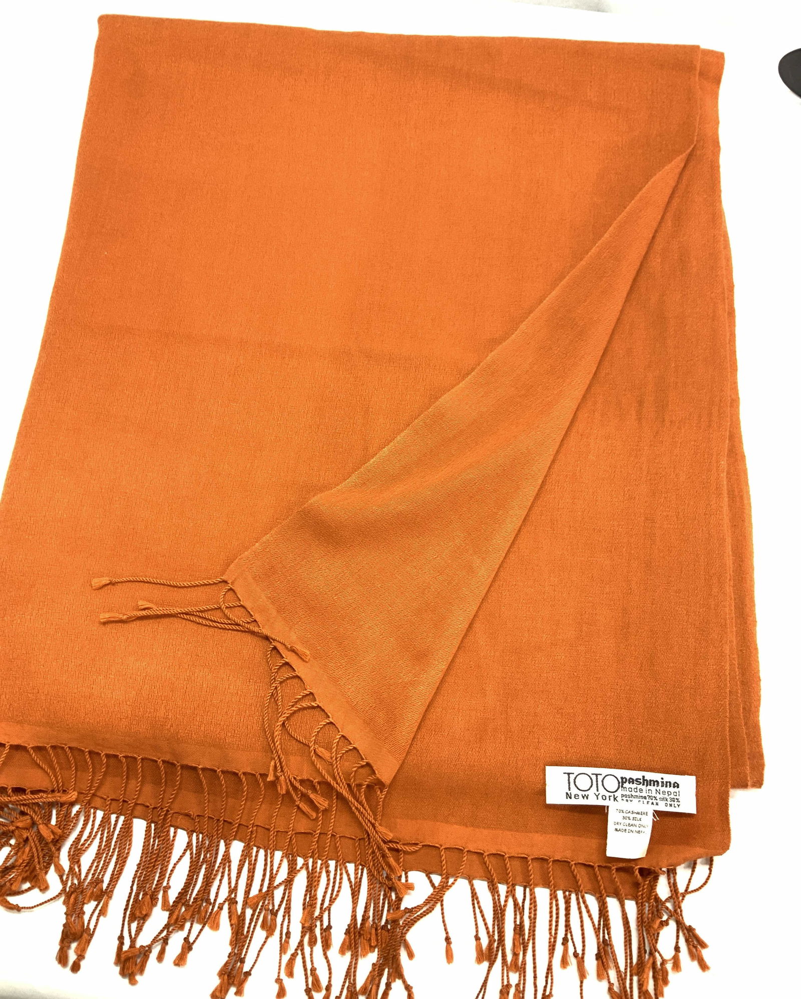 Orange Pashmina Shawl by Toto New York, Nepal: 70% cashmere, 30% silk orange pashmina with tassels , made in Nepal. 36.5 x 86 in. Designer label Toto New York. Luxury Pashmina Shawl, Made in Nepal Shawl, Cashmere and Silk Shawl , Ladies Accessorie
