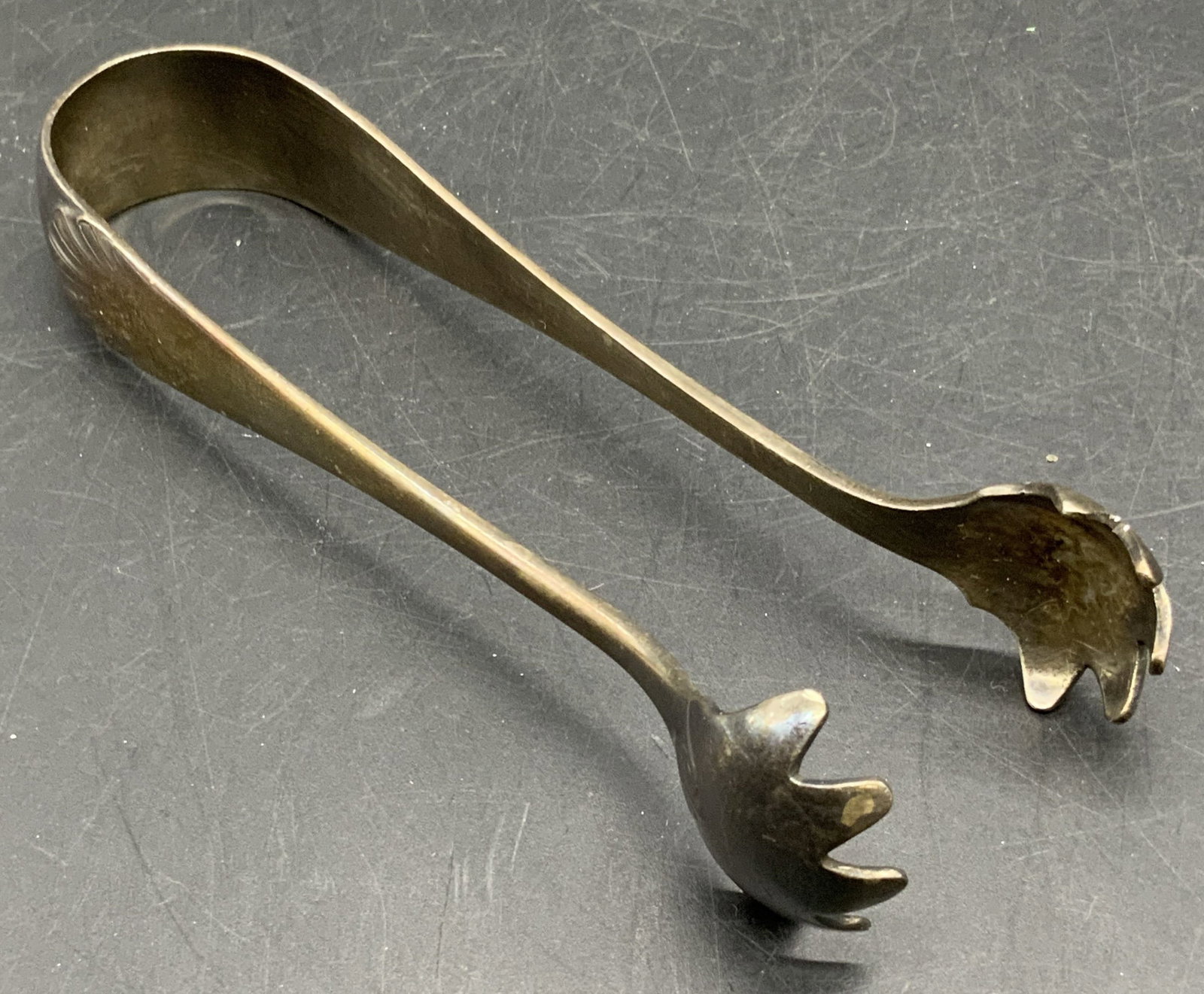 Vintage ART KRUPP BERNDORF Silver Plate Tongs: Vintage silver plated tongs with raised metalwork designs. Obverse stamped GRAND CONTINENTAL CAIRO, ART KRUPP BERNDORF. Measures approx. 5.25L x .75W in. Some surface wear and discoloration consistent