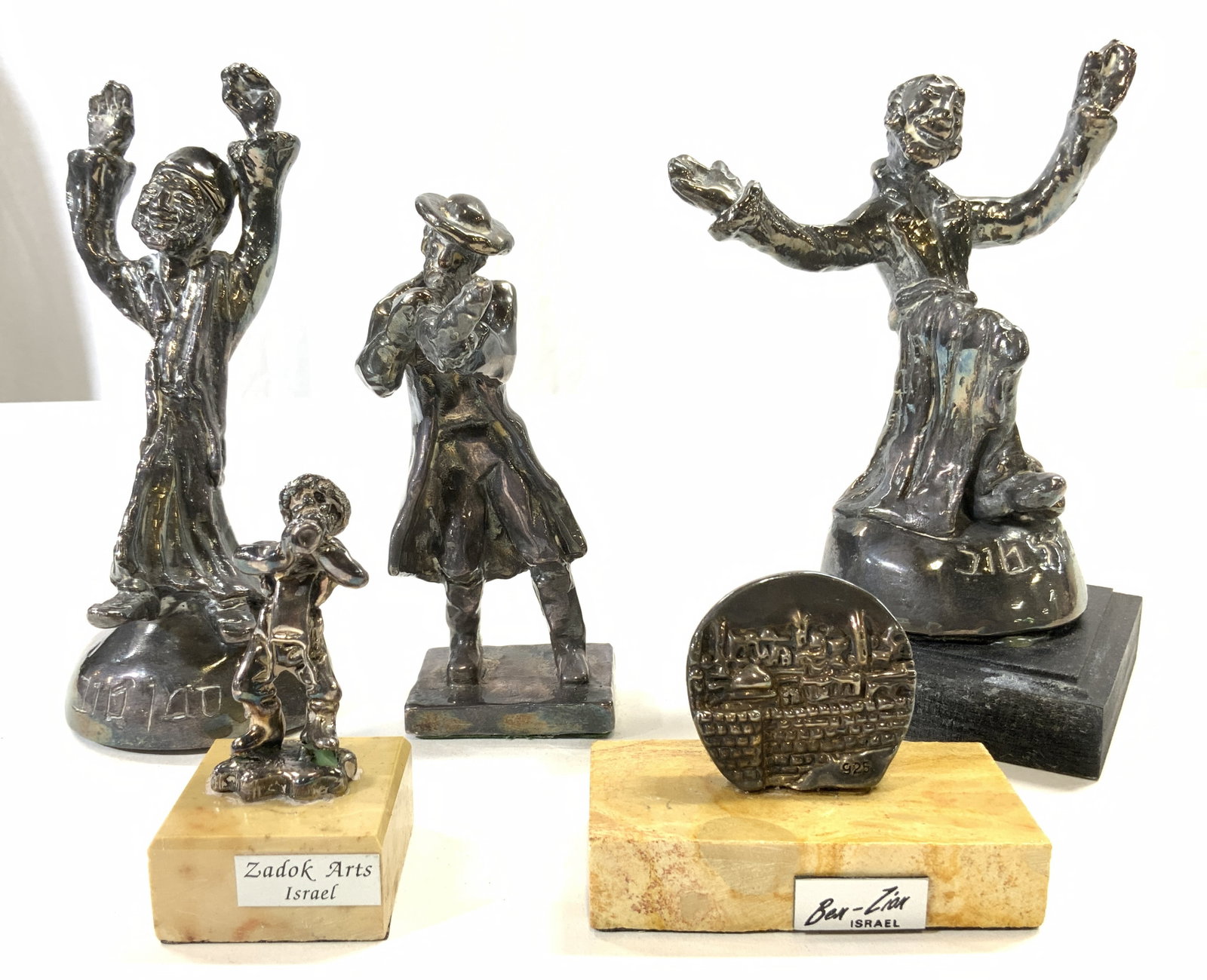 Sterling Silver Lot 5 Judaica Figures: Each piece is inscribed 925. Lot includes 1 figure with arms out w base 8.63 OZT, 1 figure playing an instrument 3.08 OZT, 1 seated figure with arms raised 5.66 OZT, 1 small figure playing instrument 