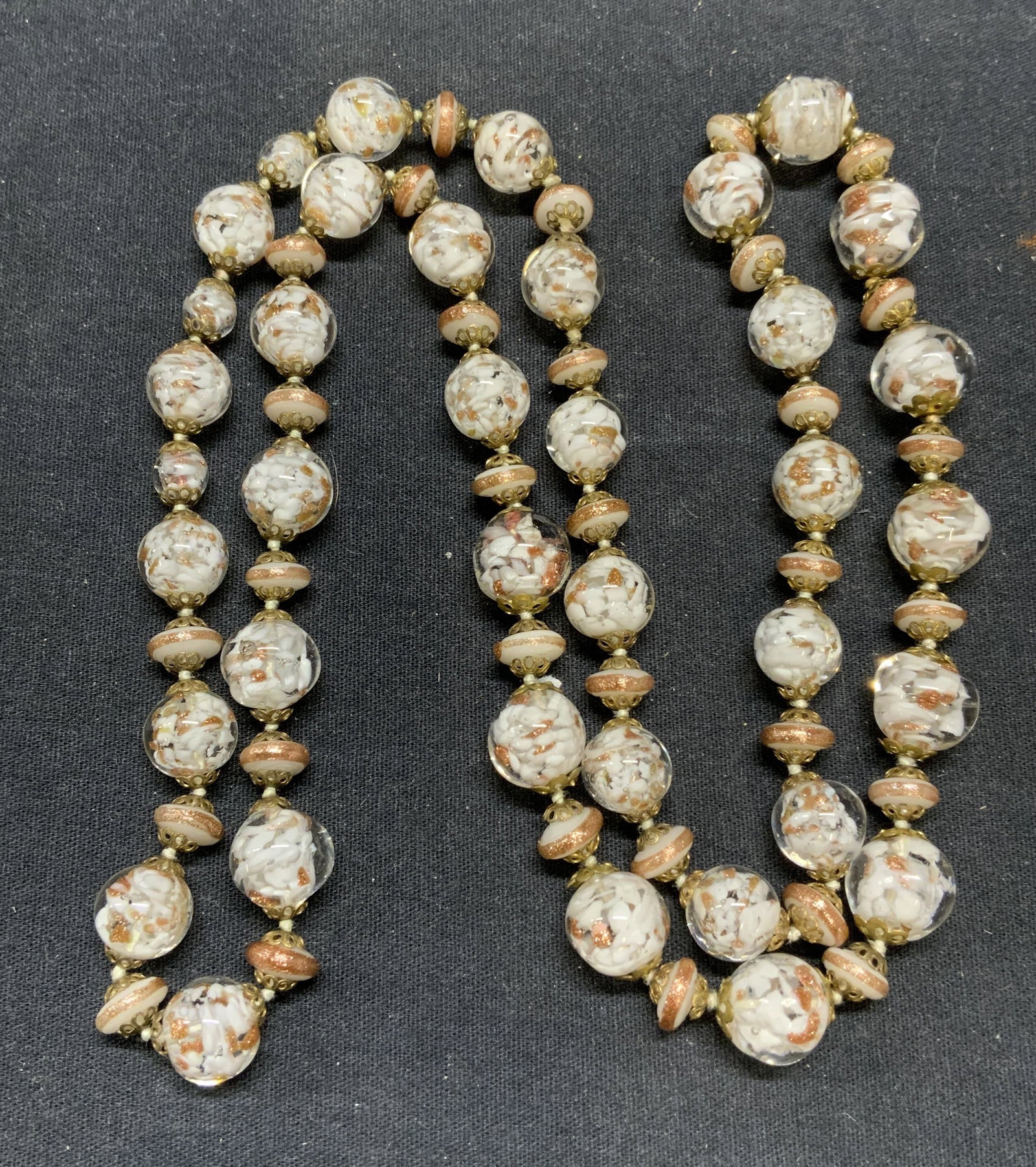 Art Glass White & Metallic Beaded Necklace: Art glass beaded necklace with transparent, white, and copper metallic toned beads. Drop length approx. 17.5 inches. Some surface wear consistent with exposure. Estate jewelry, costume jewelry, cockta