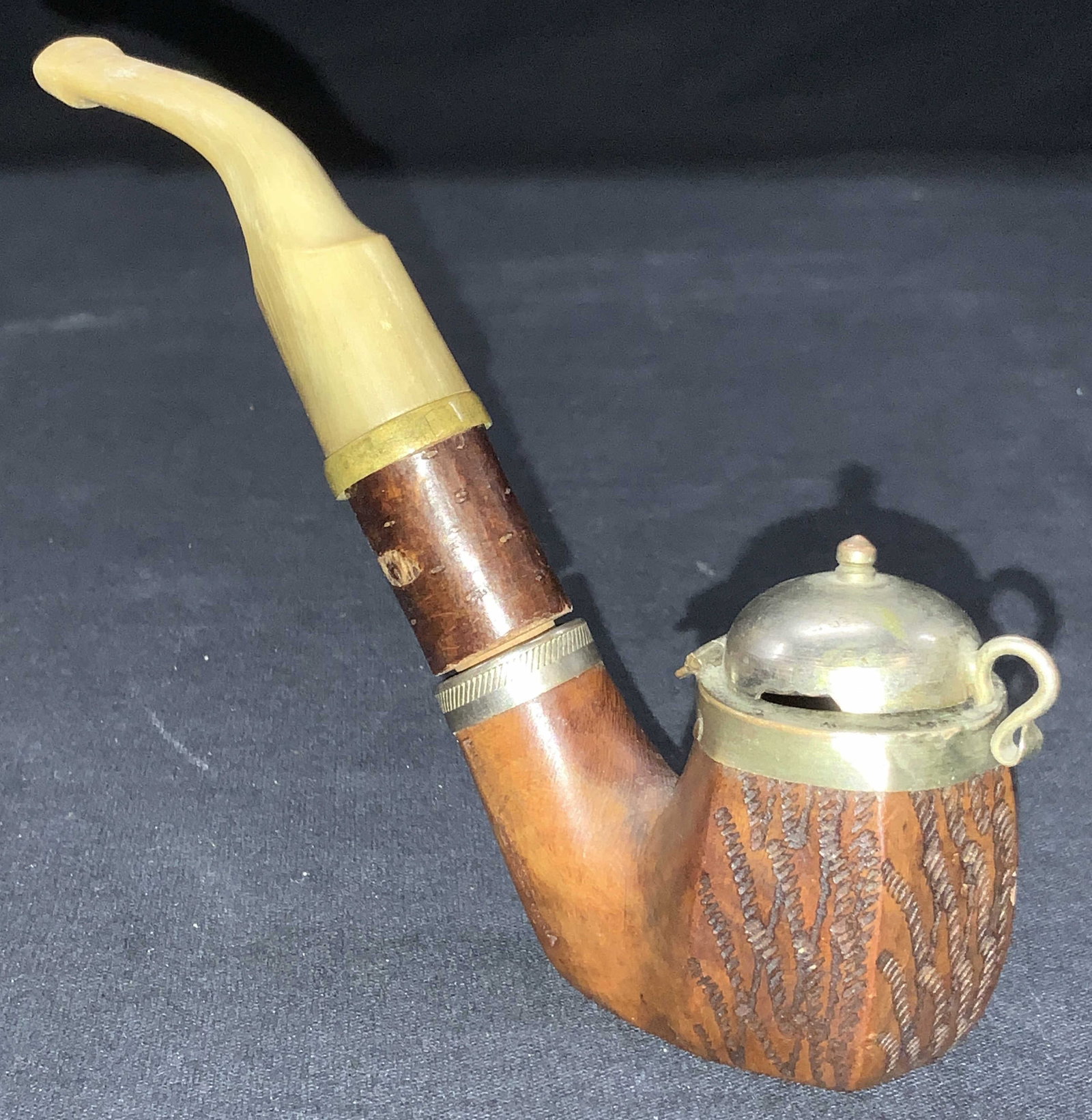 Vintage SP & Wood & Bone Tobacco Pipe: Vintage tobacco pipe with body made of different section wood, silver plated pipe cap and possible carved bone mouth piece. Approximately 5 inches wide and 4.5 inches standing. Moderate wearing throug