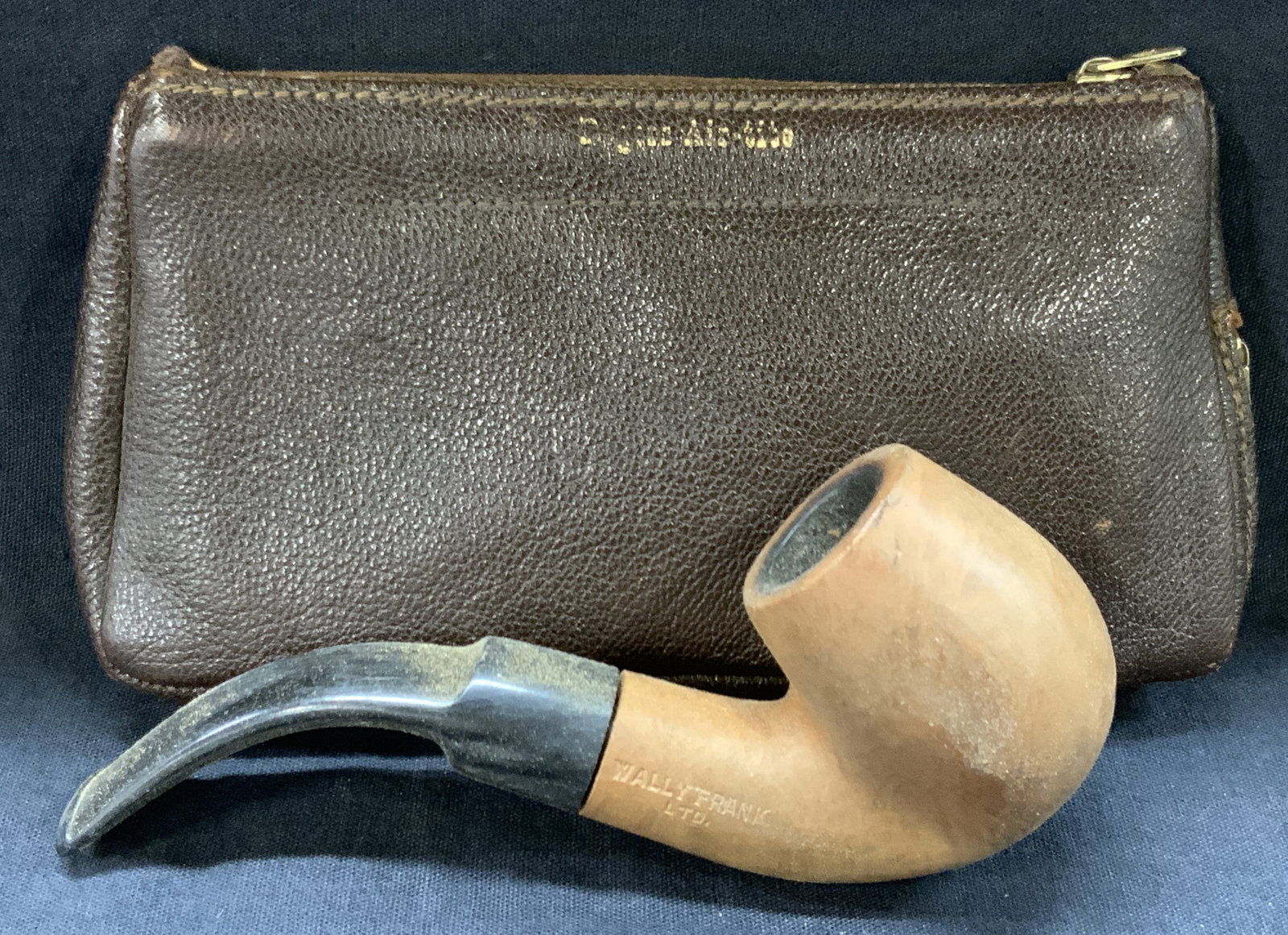 Vintage Leather Tobacco Pouch W Pipe: Brown leather pouch, marked English Morocco with two zippers, 1 for main pocket, possibly for tobacco and the other underneath for storing pipes. Tan toned wooden pipe marked Wally Frank, natural impo