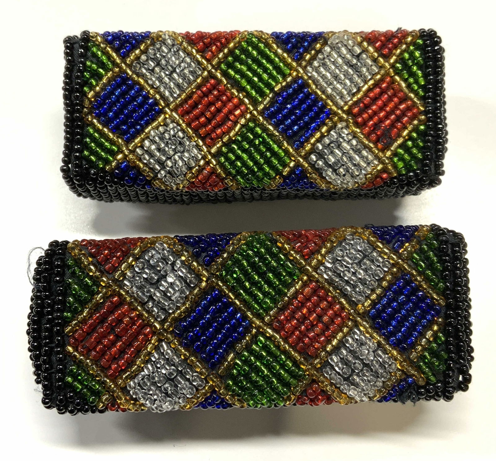 Pair Vintage Beaded Lipstick Cases: Pair of vintage beaded lipstick cases with mirrors. Measure approx. 3.25 x 1.25 x 1 1/8 inches. Some surface wear to each consistent with exposure. Lipstick case, beaded lipstick case, makeup case, co