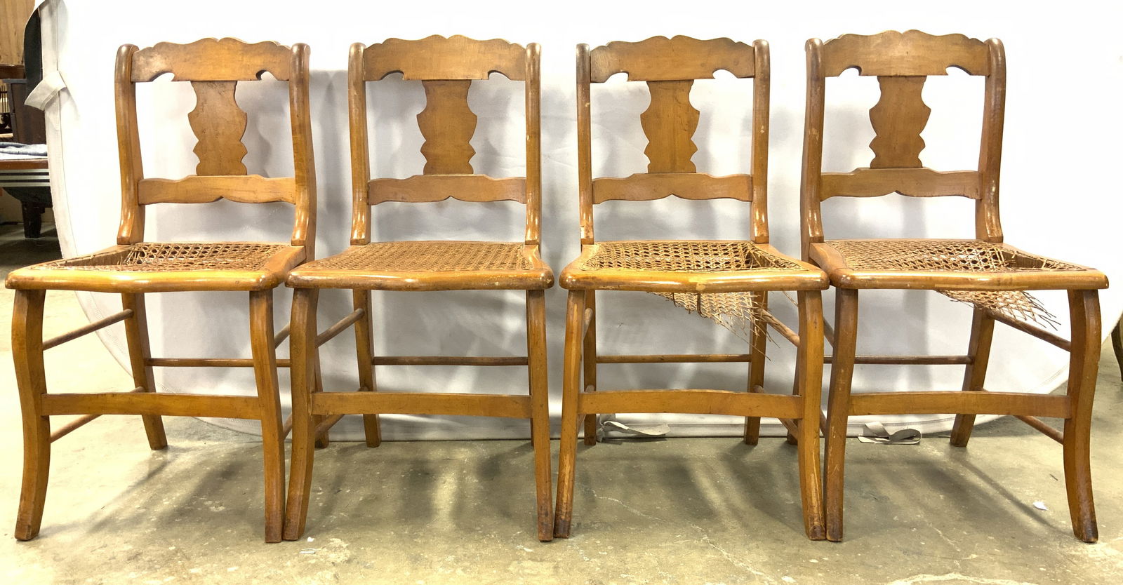 4 Antique Early American Wood & Cane Seat Chairs: Lot includes 4 side chairs. Each are vintage and wooden. Chairs each have caned seats. Backrests have vase shape. Legs have box stretchers in between. Chairs each measure approximately 32 inches tall