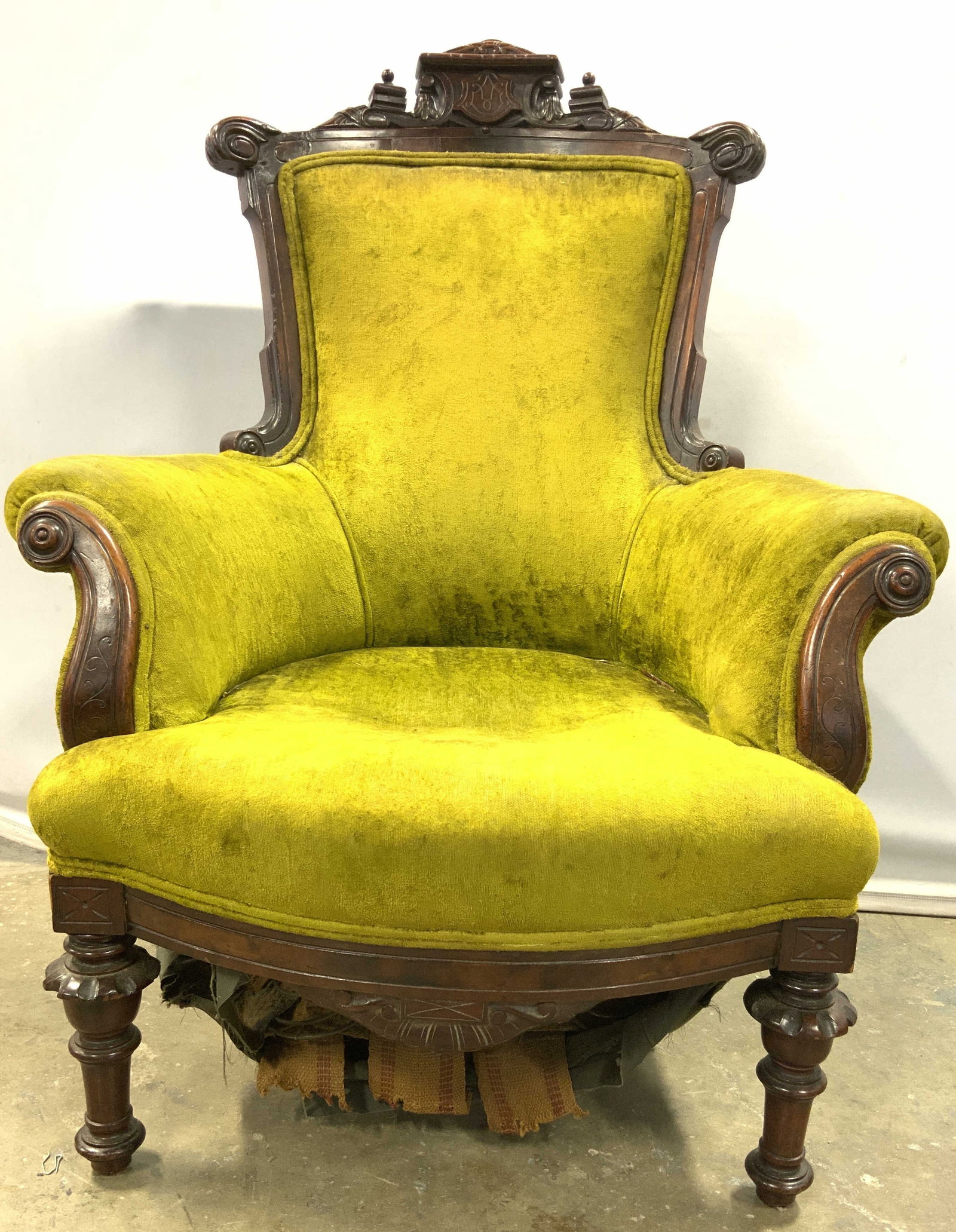 Eastlake Style Armchair W Turned Legs: Armchair is vintage and wooden. Piece has green toned upholstery with double welting at edges. Chair frame is brown toned and wooden with intricately carved detail & turned legs. Piece has Eastlake st