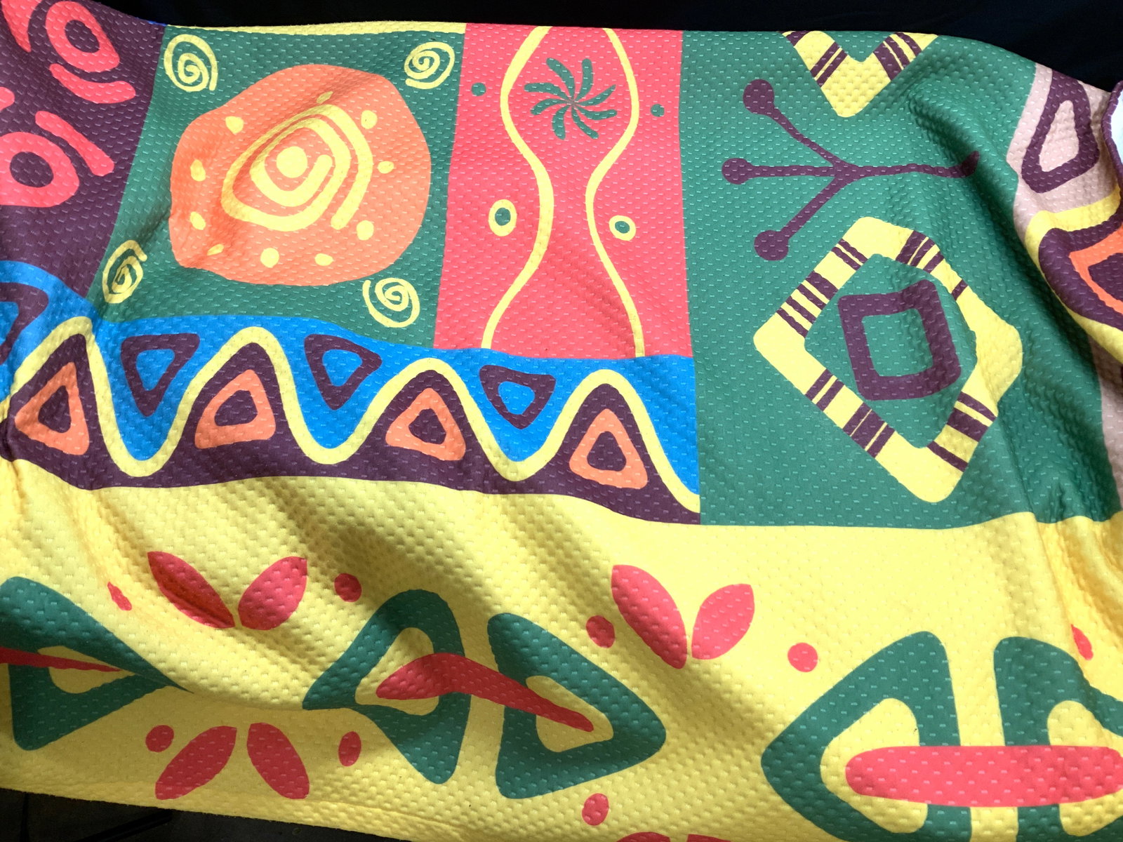 Queen Bedspread Coverlet, Turkey: Bright Colorful Queen Size Coverlet of African designs. Green, yellow, coral color palette. made in Turkey. 100% polyester. Care label attached to item . Couple of thread pulls ( see picture) in good