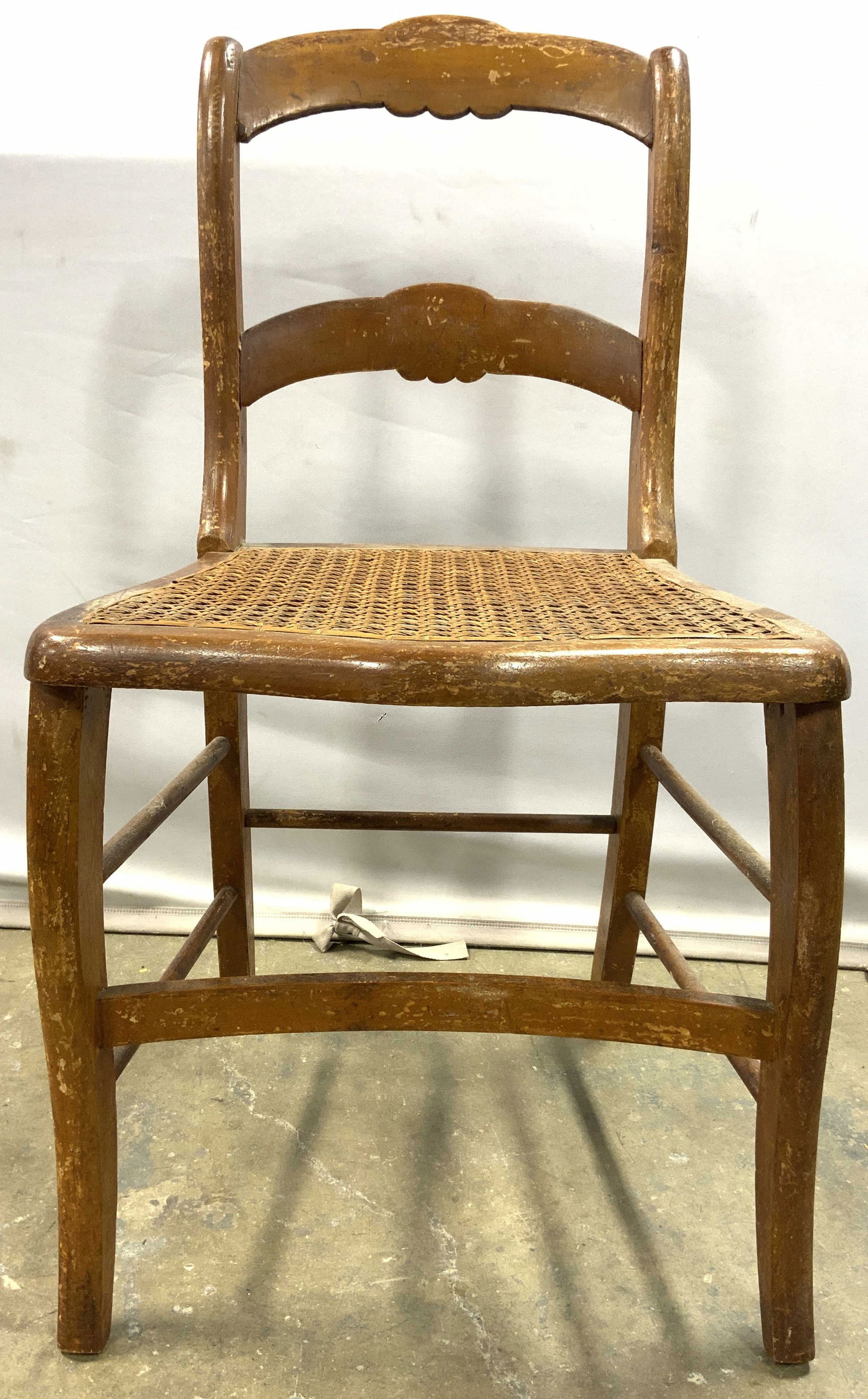 Antique Early American Wood & Cane Seat Chair: Chair is antique and wooden. Chair has caned seats. Backrest has ladder shape. Legs have box stretchers in between. Chair measures approximately 32 inches tall 17 inches wide 18 inches deep. Chair, si