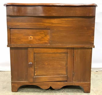 ANTQ PRMITIVE PINE LIFT TOP WOOD COMMODE: Commode is vintage possibly antique. Piece has lift top, one drawer & 1 cabinet area. Door has knob shaped handle. Measures approx 29 inches wide 17 inches deep 29.5 inches tall. Commode, wooden commo