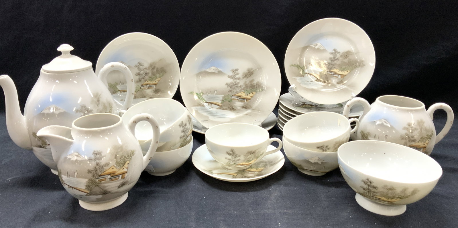 Set 28 Signed Hand Painted Porcelain Dishware: Set of 28 hand painted porcelain dishware, all signed on underside with Chinese characters and each has painted motif of a village with Mt Fuji in the background. Consists of 1 coffee pot, 8 inches ta