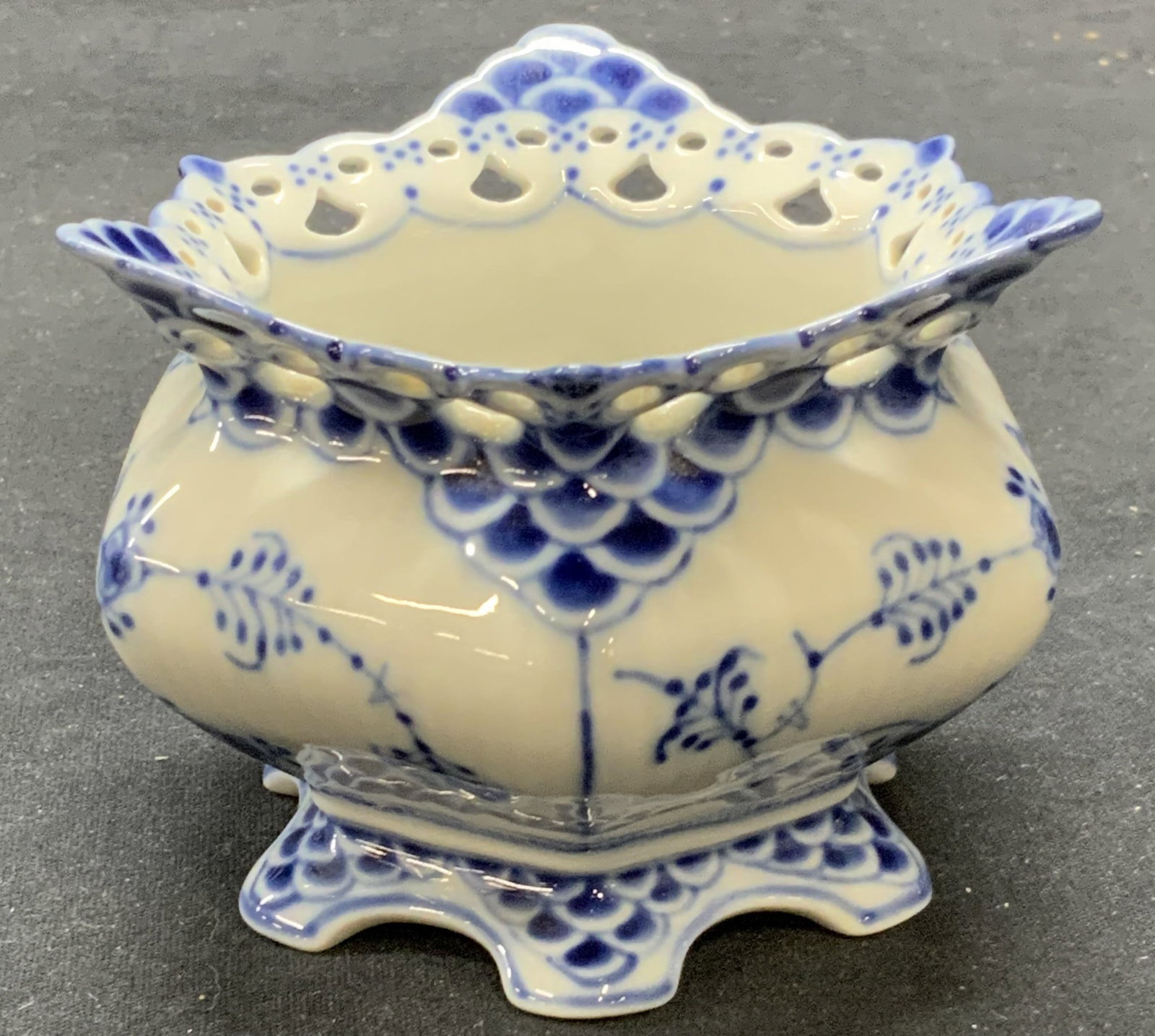 Royal Copenhagen Blue Fluted Lace Sugar Bowl: Royal Copenhagen blue fluted full lace porcelain sugar bowl. Trademarked to underside. Made in Denmark. Some surface wear consistent with exposure. Measures approx. 4 x 3 inches. Royal Copenhagen, roy